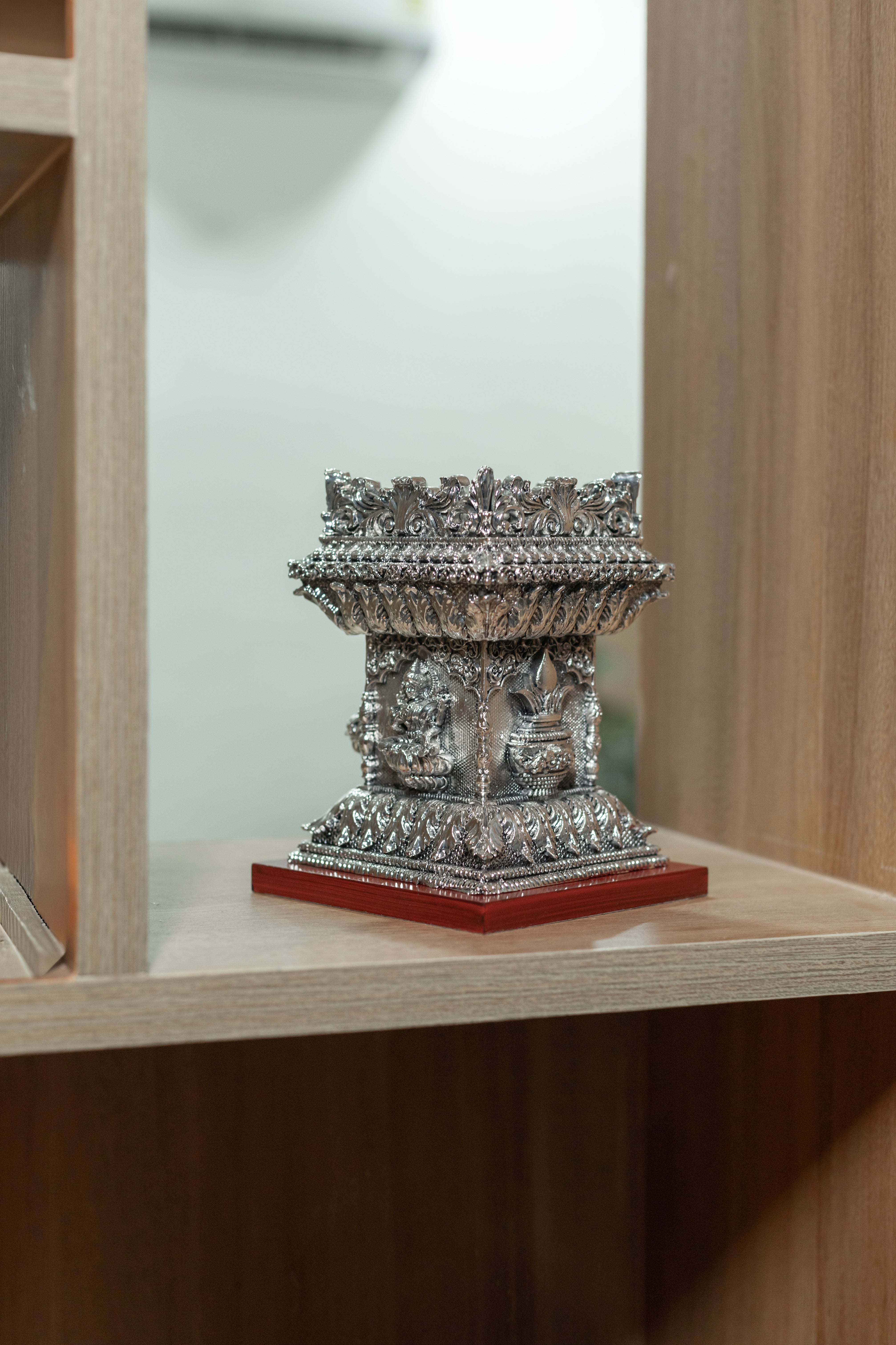 Pure silver Tulsi pot from Rasava Jewels, intricately designed silver container for religious or decorative use.