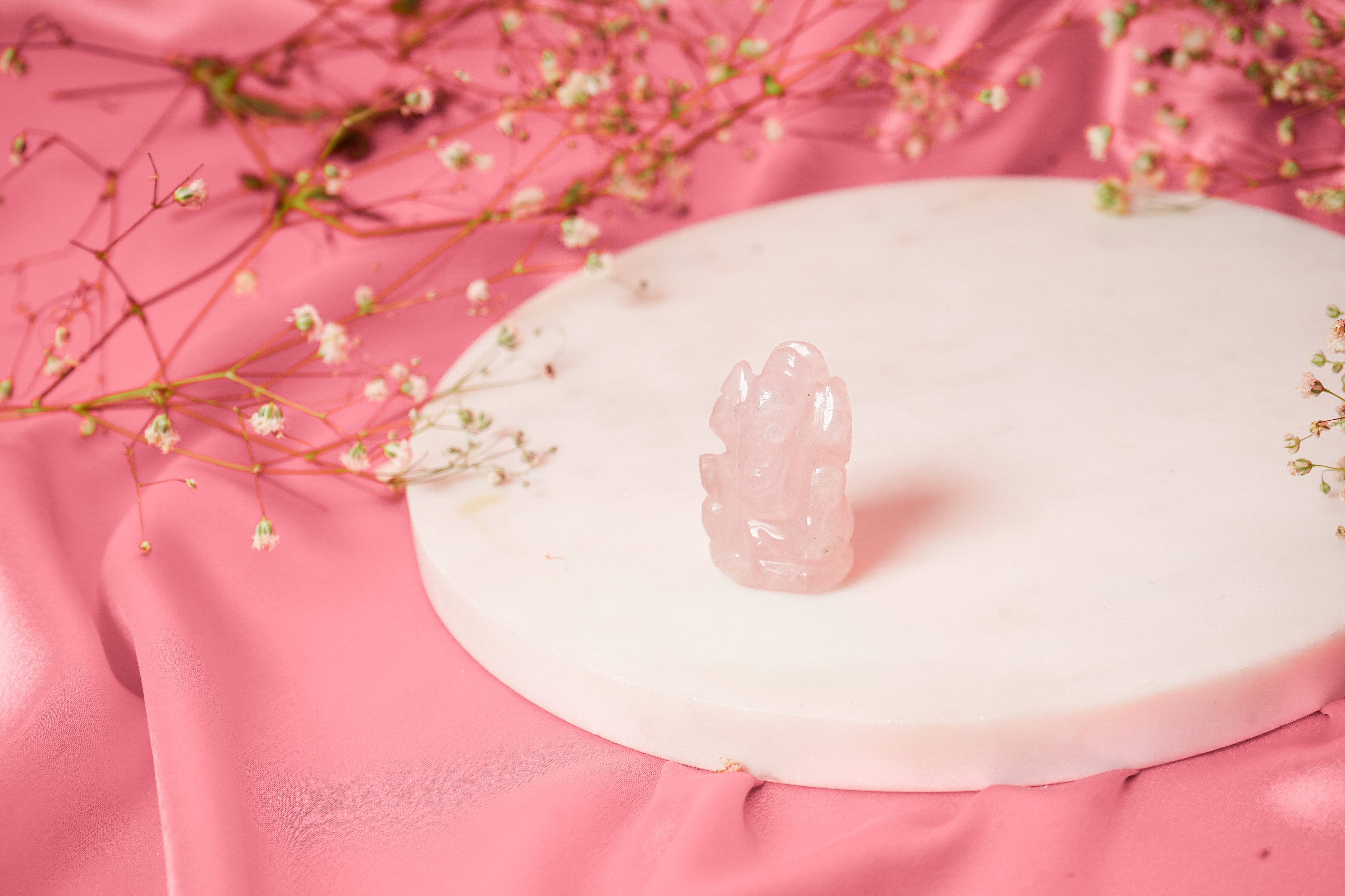 Natural Rose Quartz Ganesh Ji sculpture with intricate details, featuring soft pink hues and carved craftsmanship.