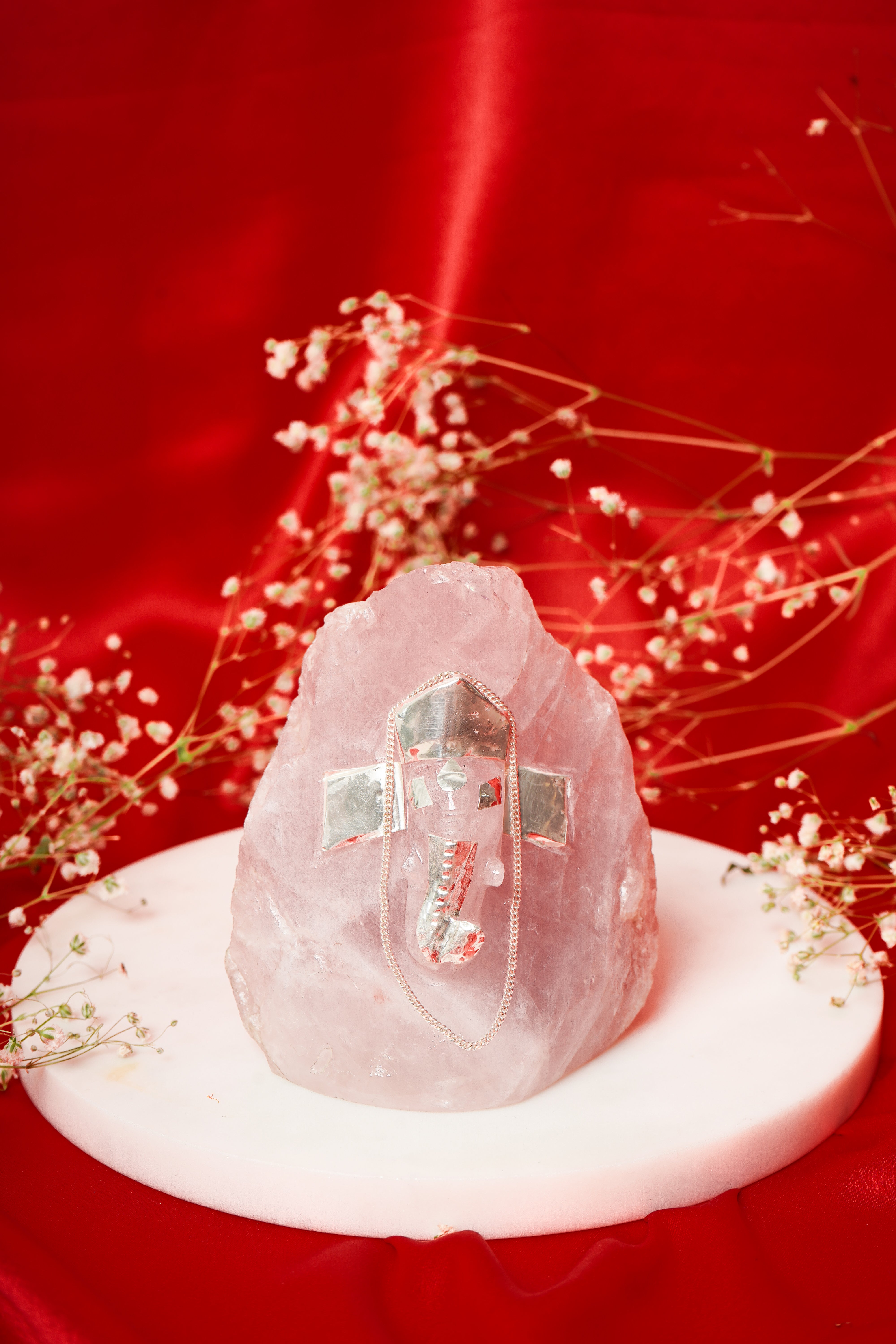 Natural rose quartz unshaped Ganesh ji sculpture with silver detailing, crafted for spiritual decor and positive energy.
