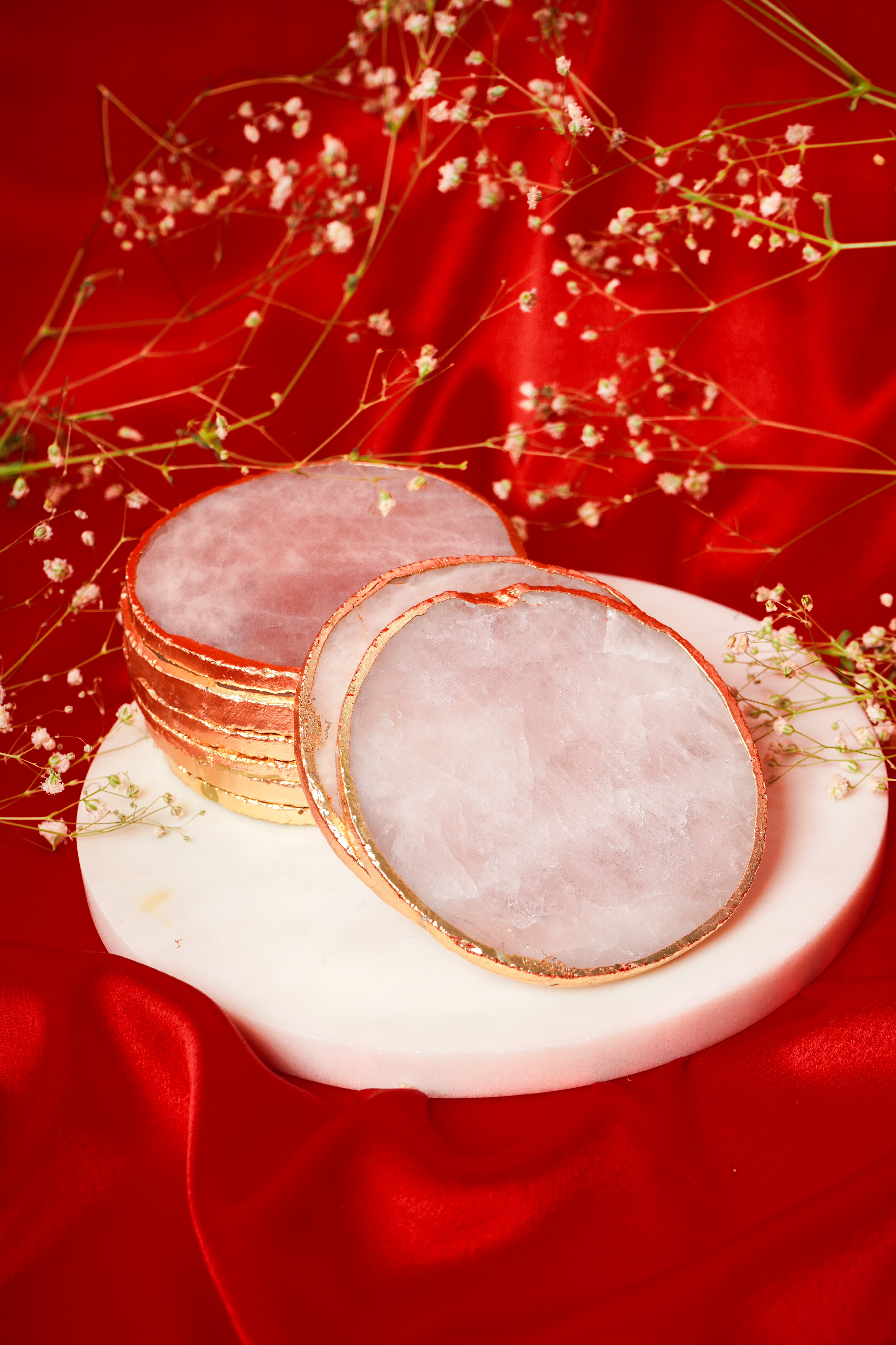 Set of natural rose quartz coasters from My Store, showcasing smooth, pink stone surfaces in a group arrangement.