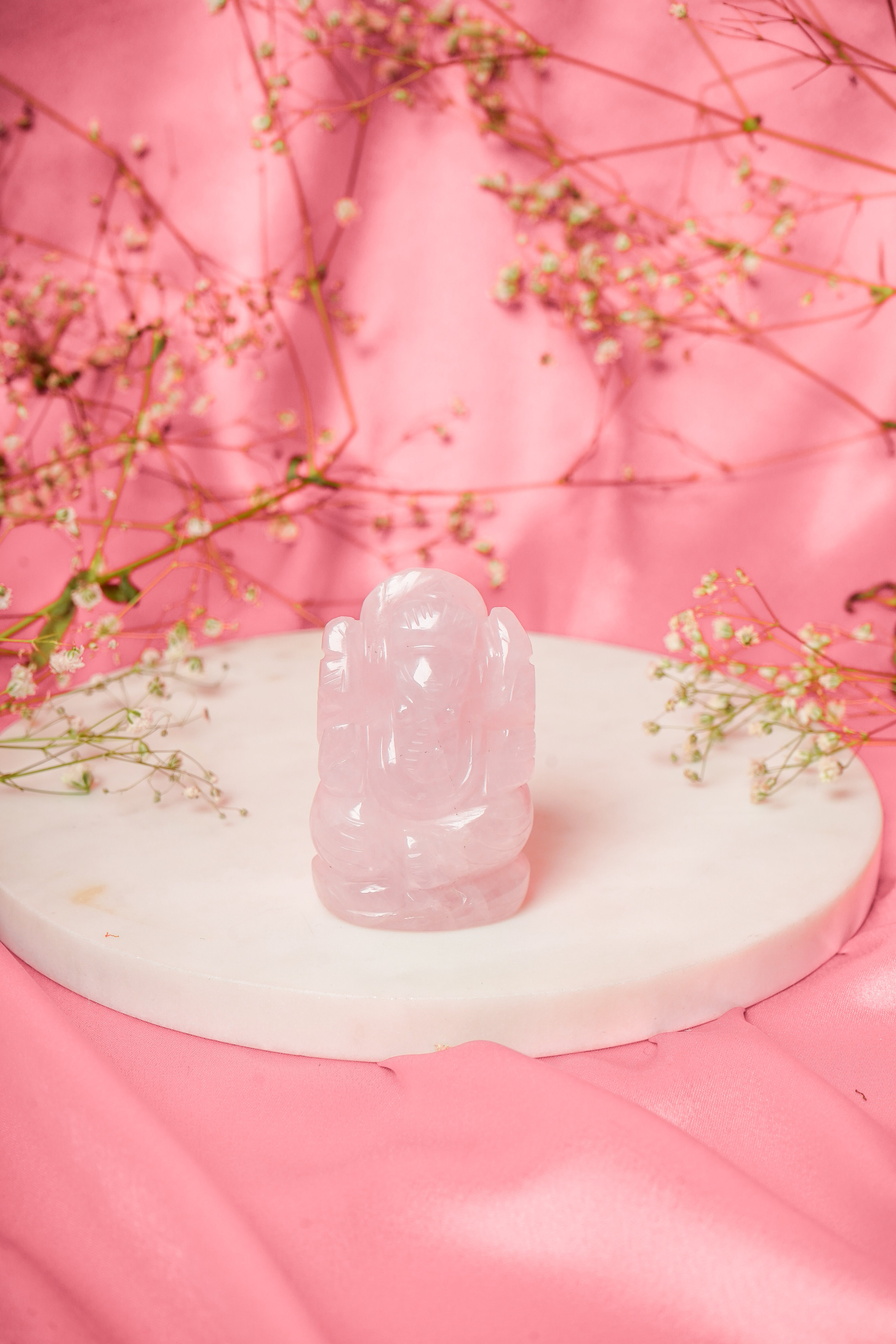 Natural rose quartz Ganesh ji statue with carved details, showcasing a serene spiritual figure from My Store.
