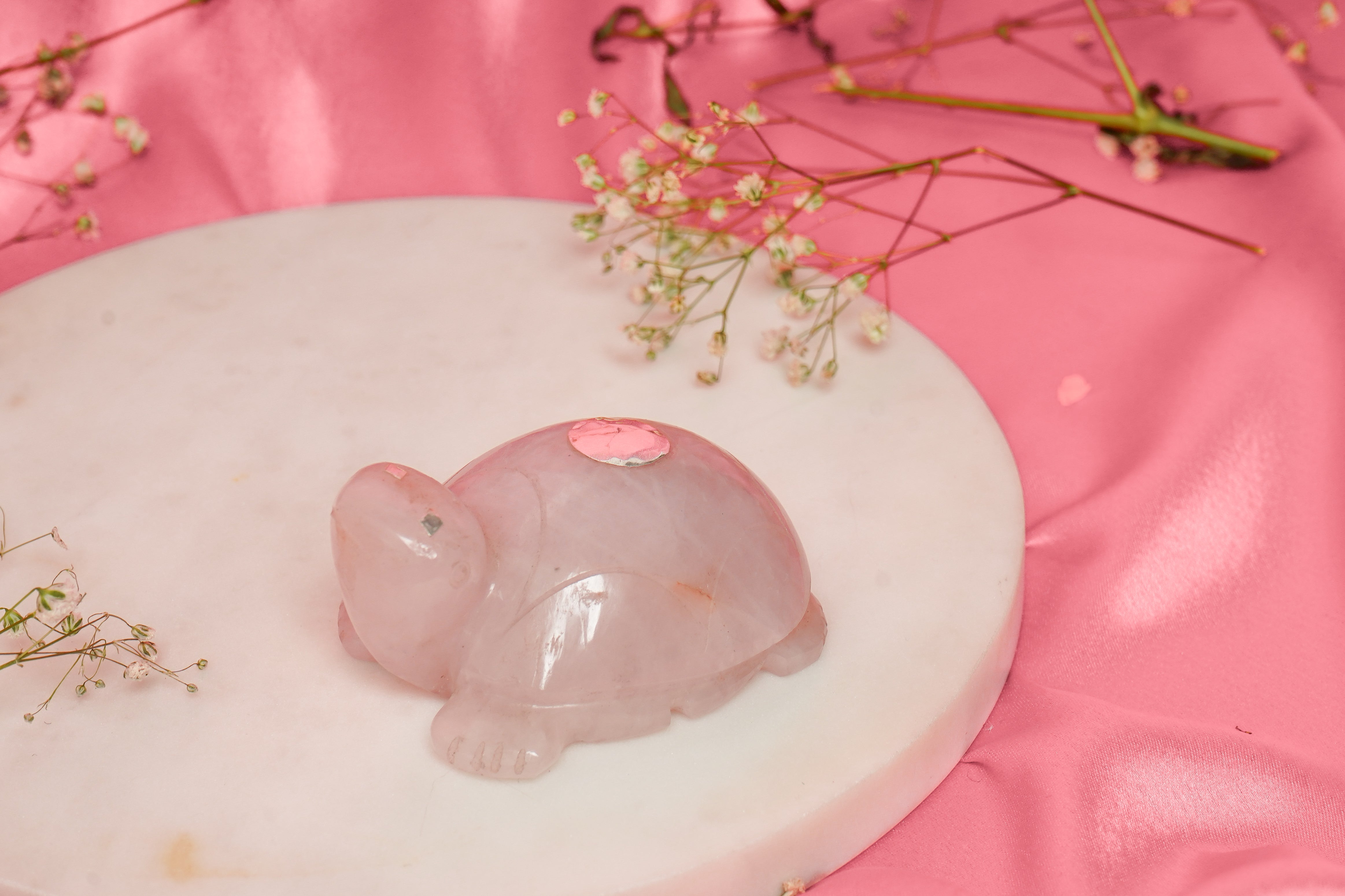 Natural rose quartz tortoise sculpture with silver accents, showcasing a smooth, polished finish and intricate detailing.