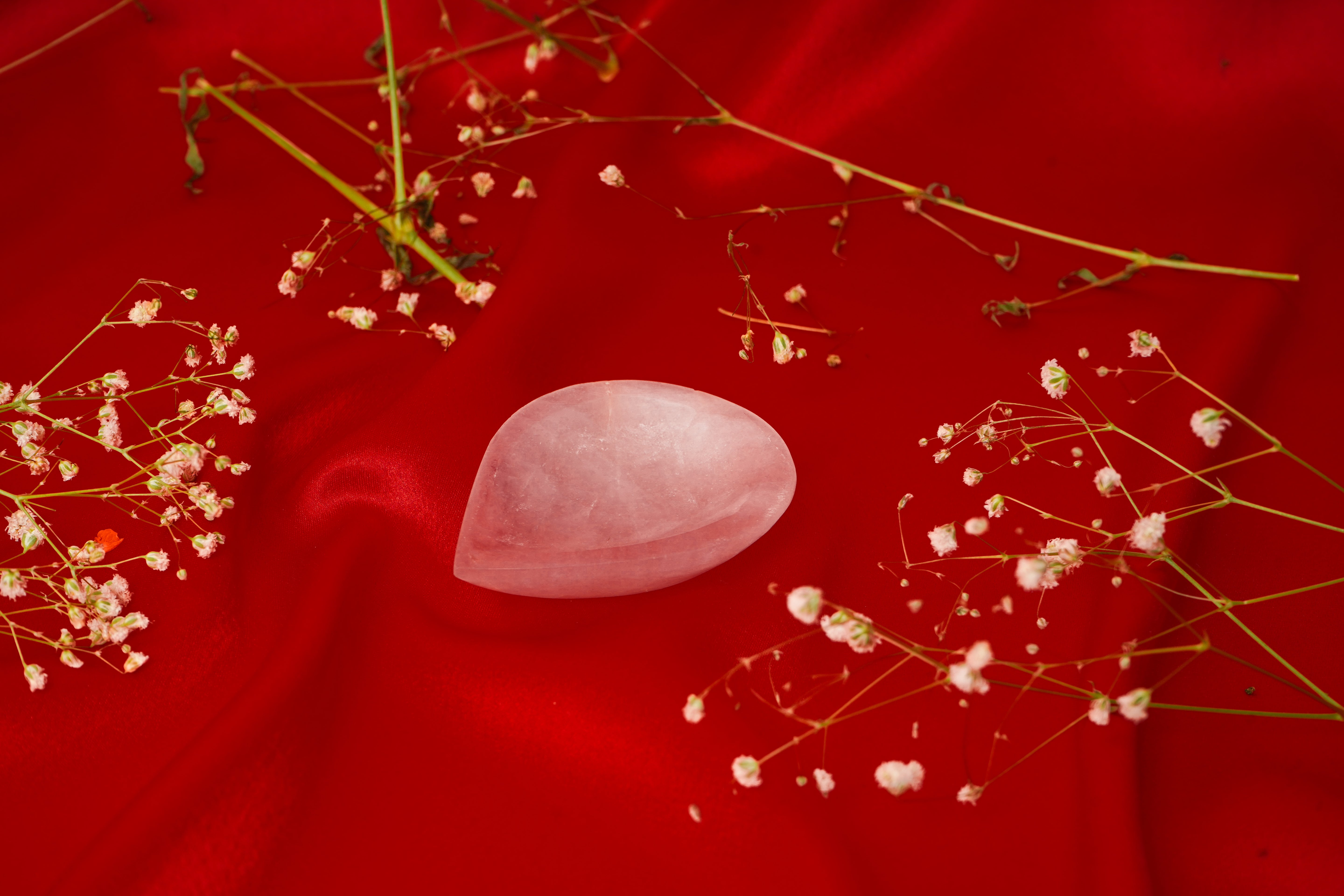 Natural rose quartz diya with intricate carvings, showcasing a soft pink hue and traditional design for spiritual or decorative use.