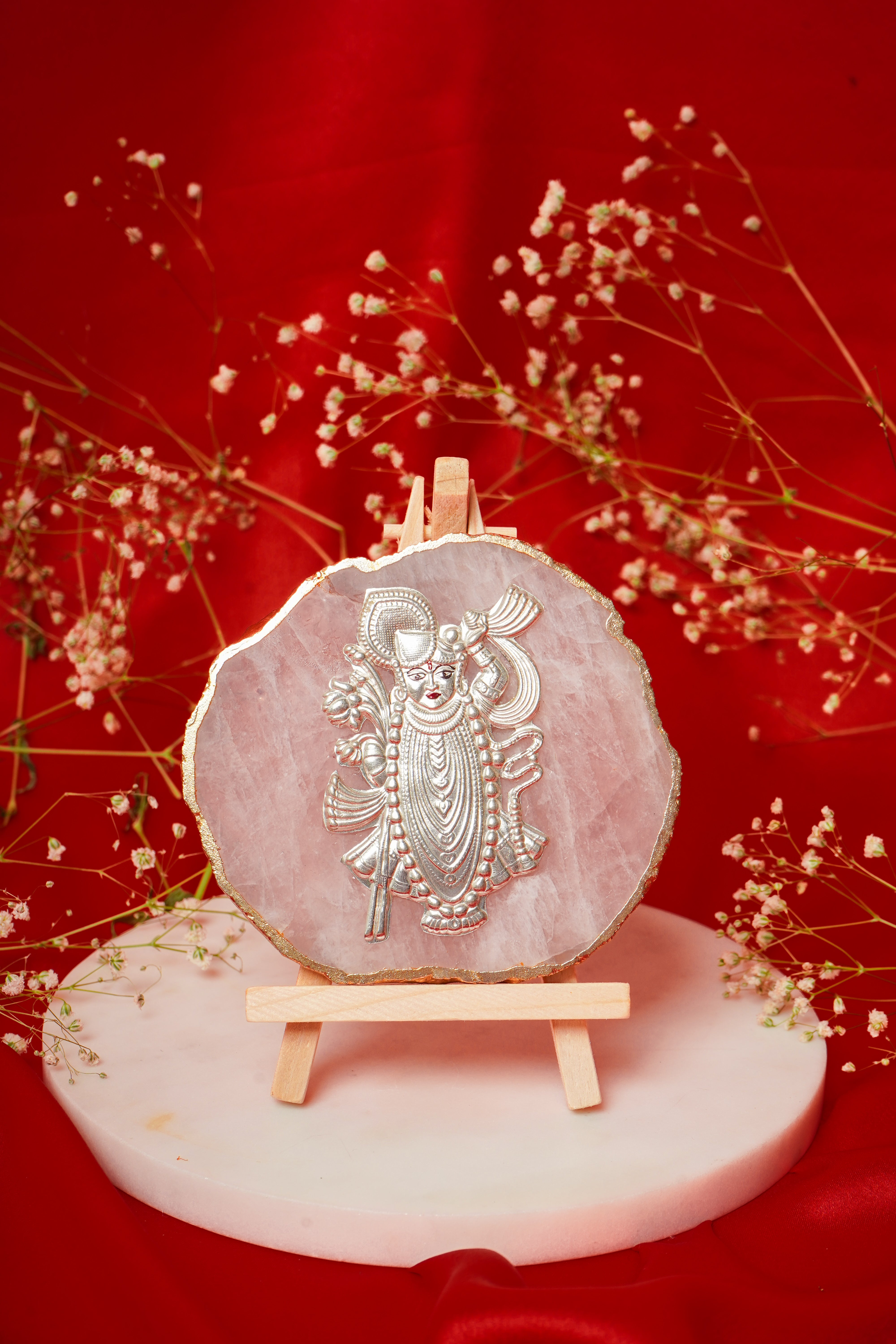 Natural rose quartz coaster featuring a Shrinath Ji figure in pure silver, showcasing intricate craftsmanship and vibrant pink hues.