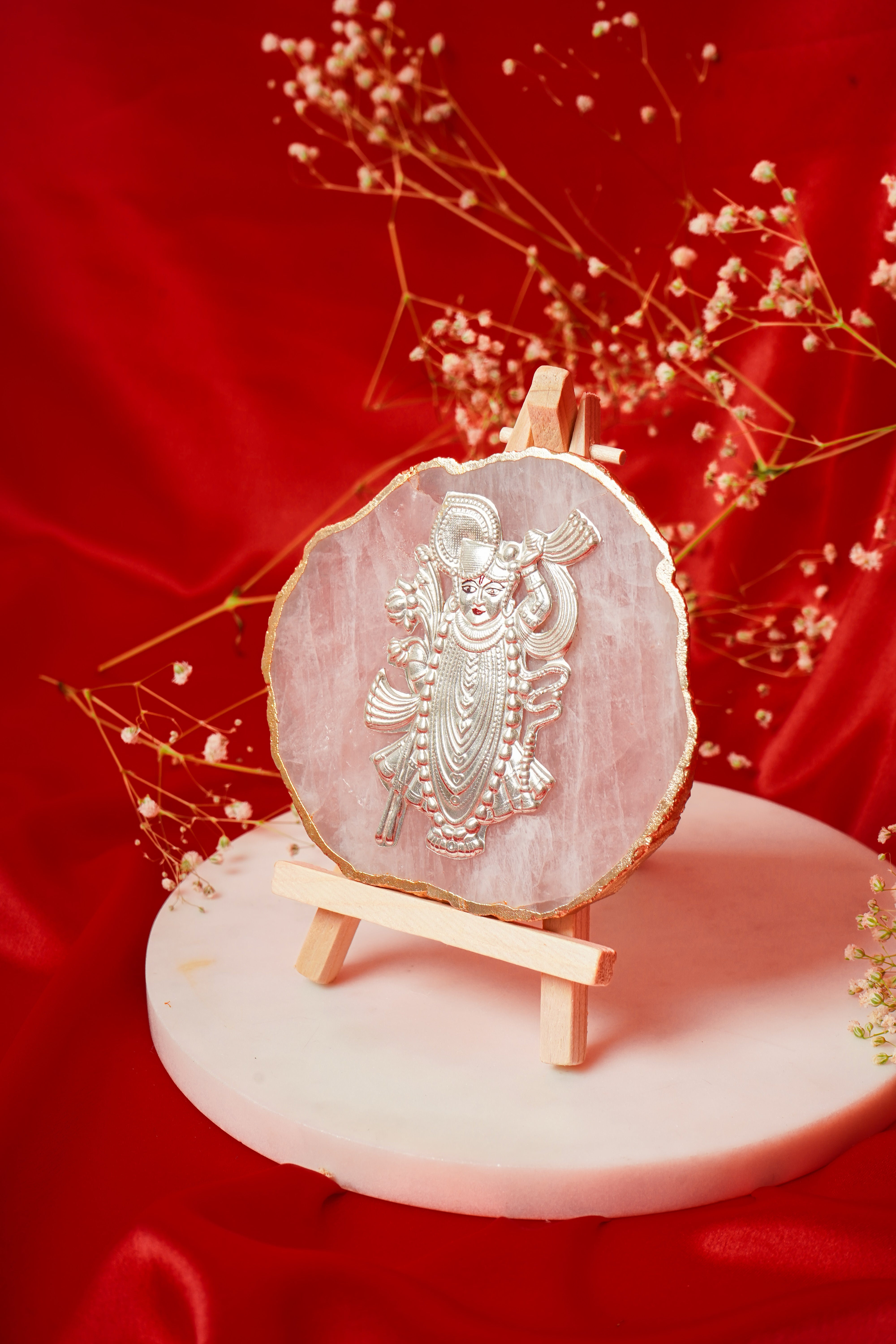 Natural rose quartz coaster with Shrinath Ji in pure silver, showcasing intricate silver detailing on a smooth rose quartz surface.