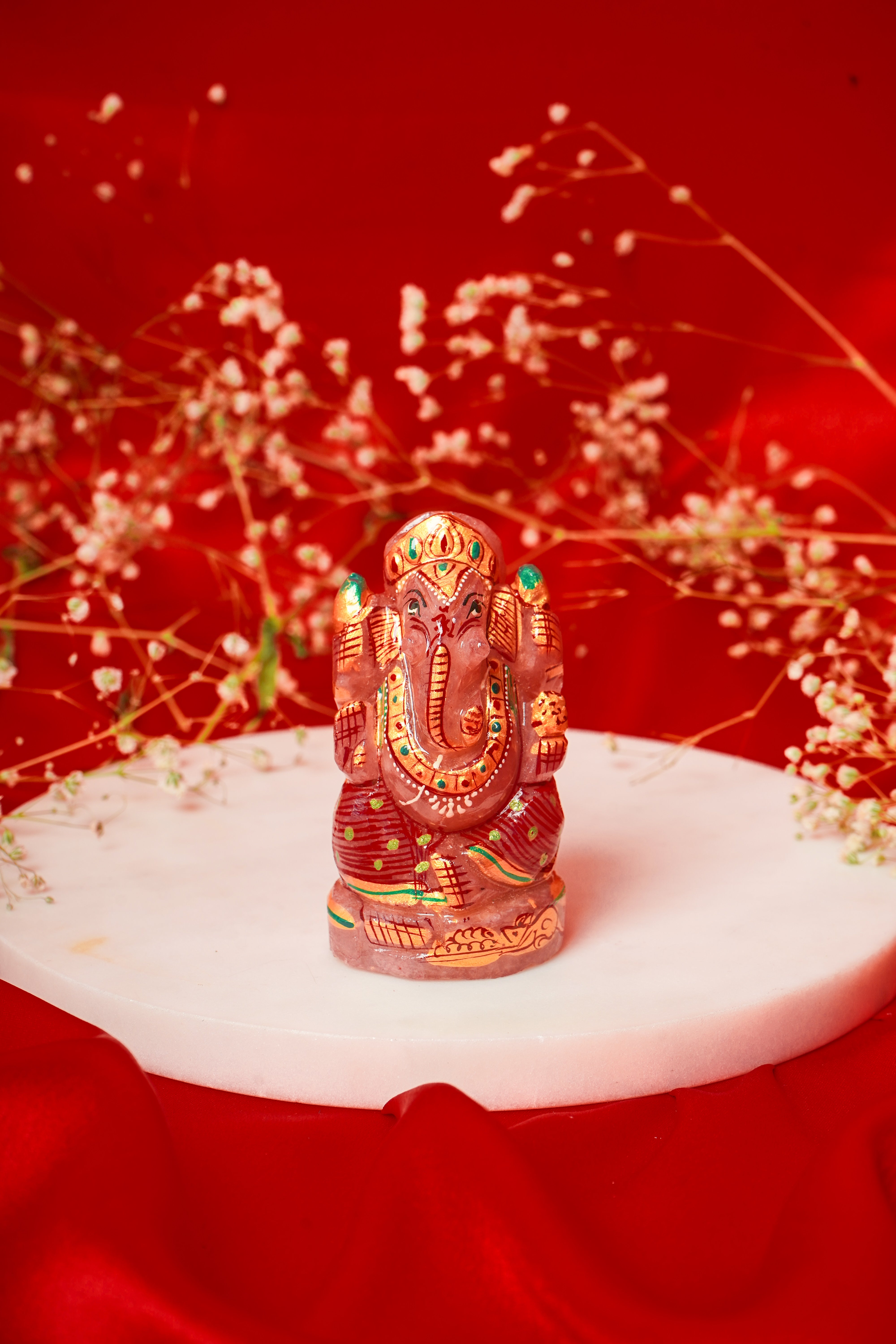 Natural rose quartz Ganesh Ji figurine with intricate meenakari detailing, crafted by My Store, showcasing vibrant colors and fine artistry.