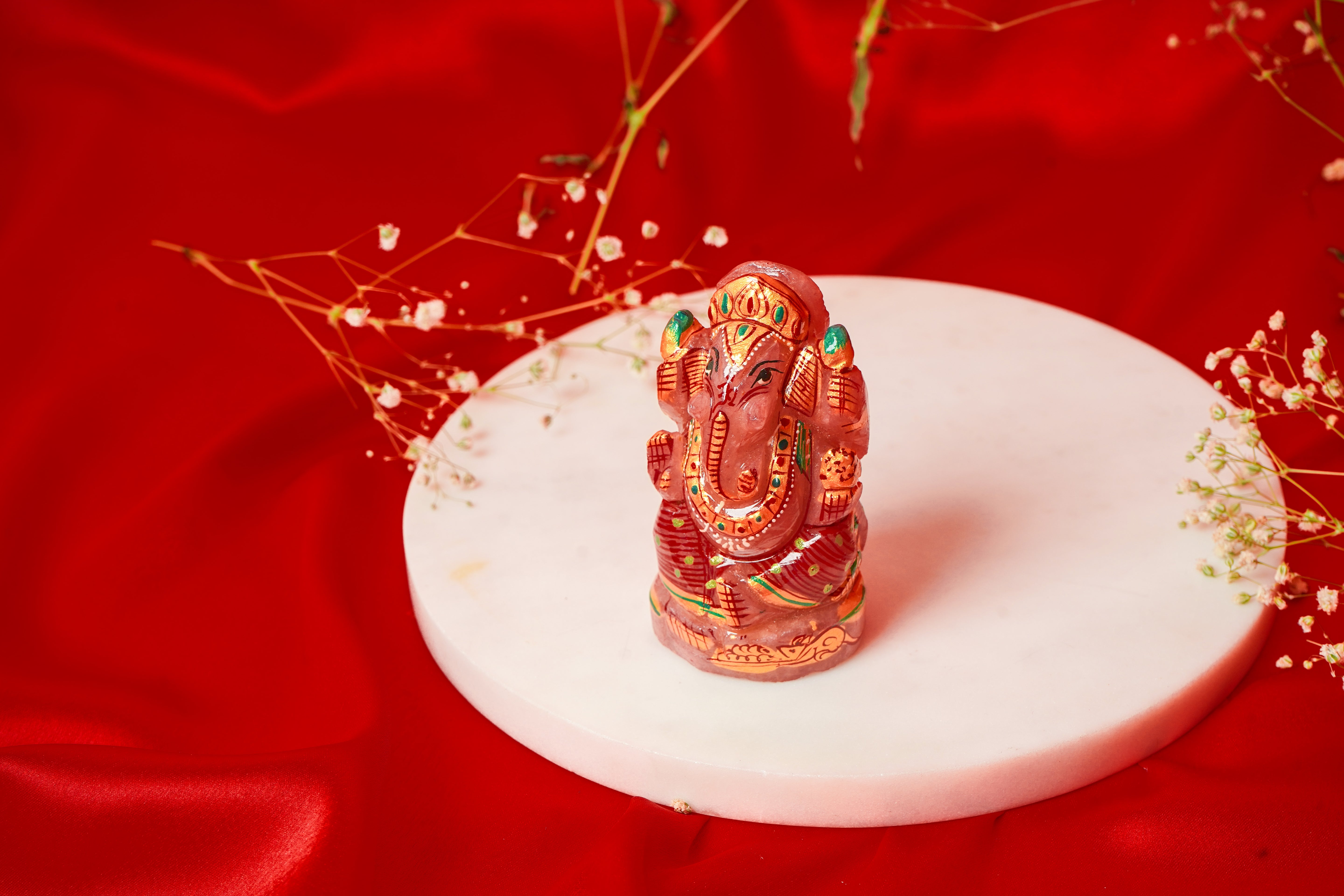 Natural rose quartz Ganesh Ji figurine with intricate meenakari detailing, crafted by My Store for spiritual and decorative use.