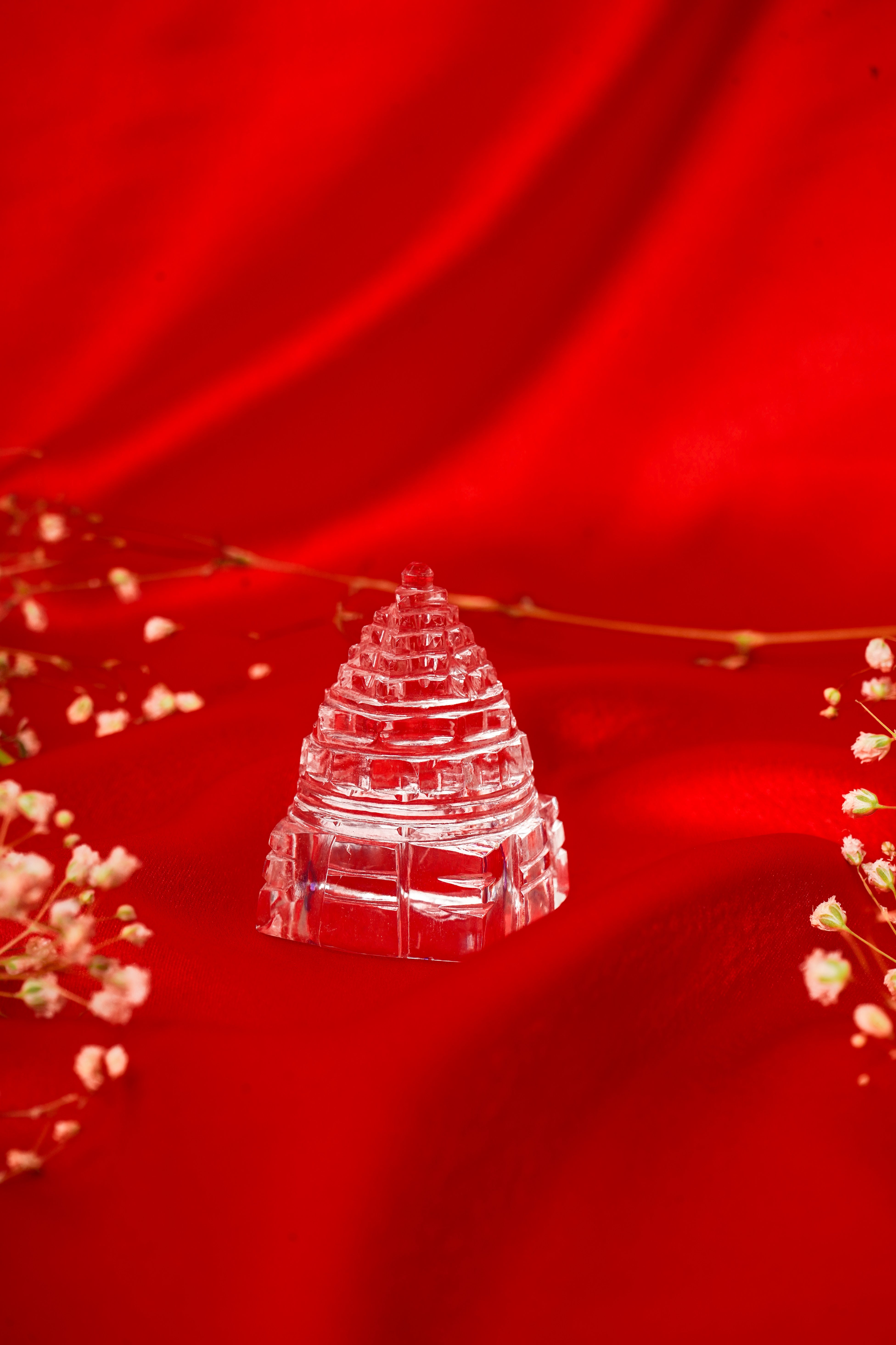 Natural clear quartz Shree Yantra pendant with intricate geometric design on a white background.