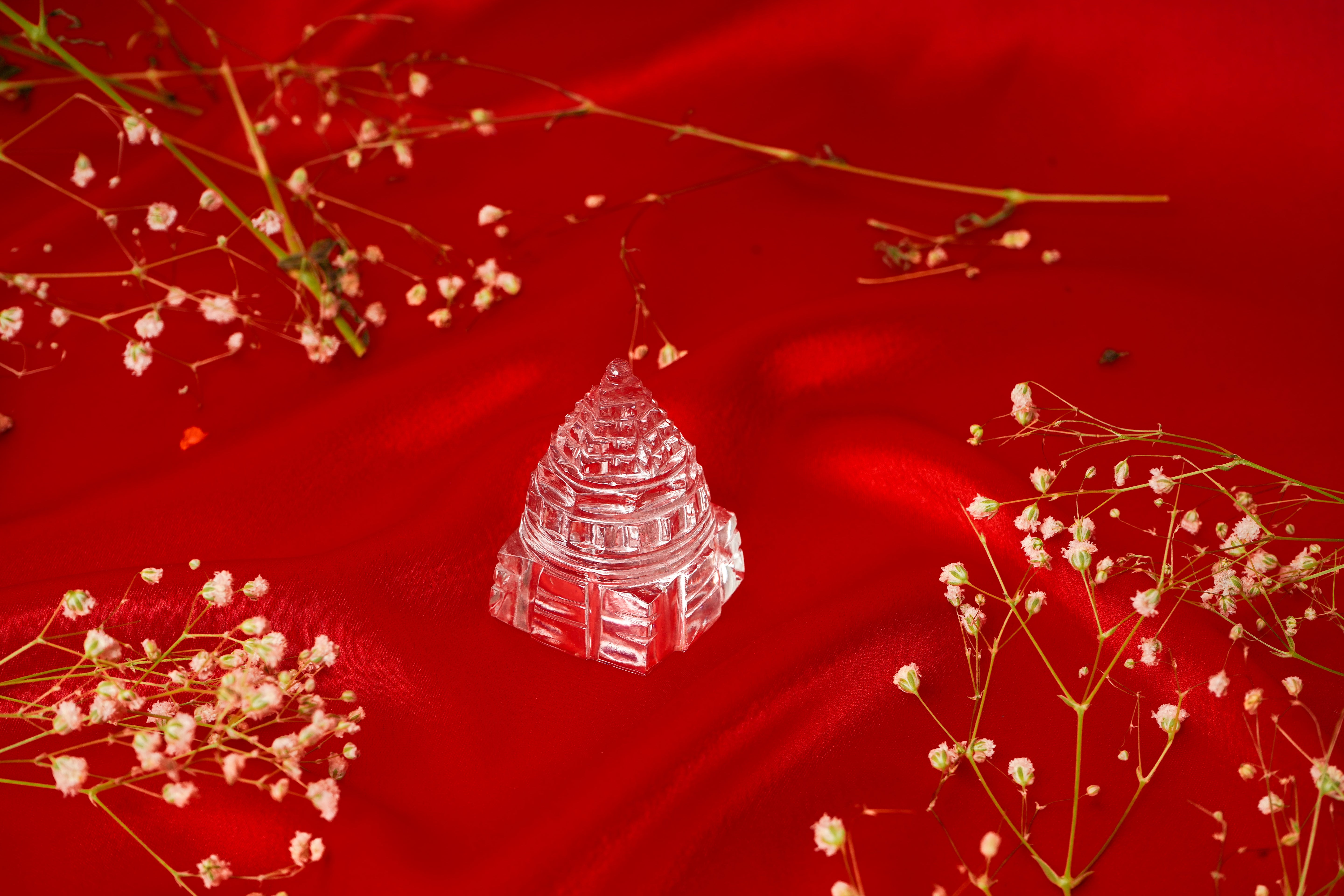 Natural clear quartz Shree Yantra sculpture with intricate design, used for meditation and spiritual practices.