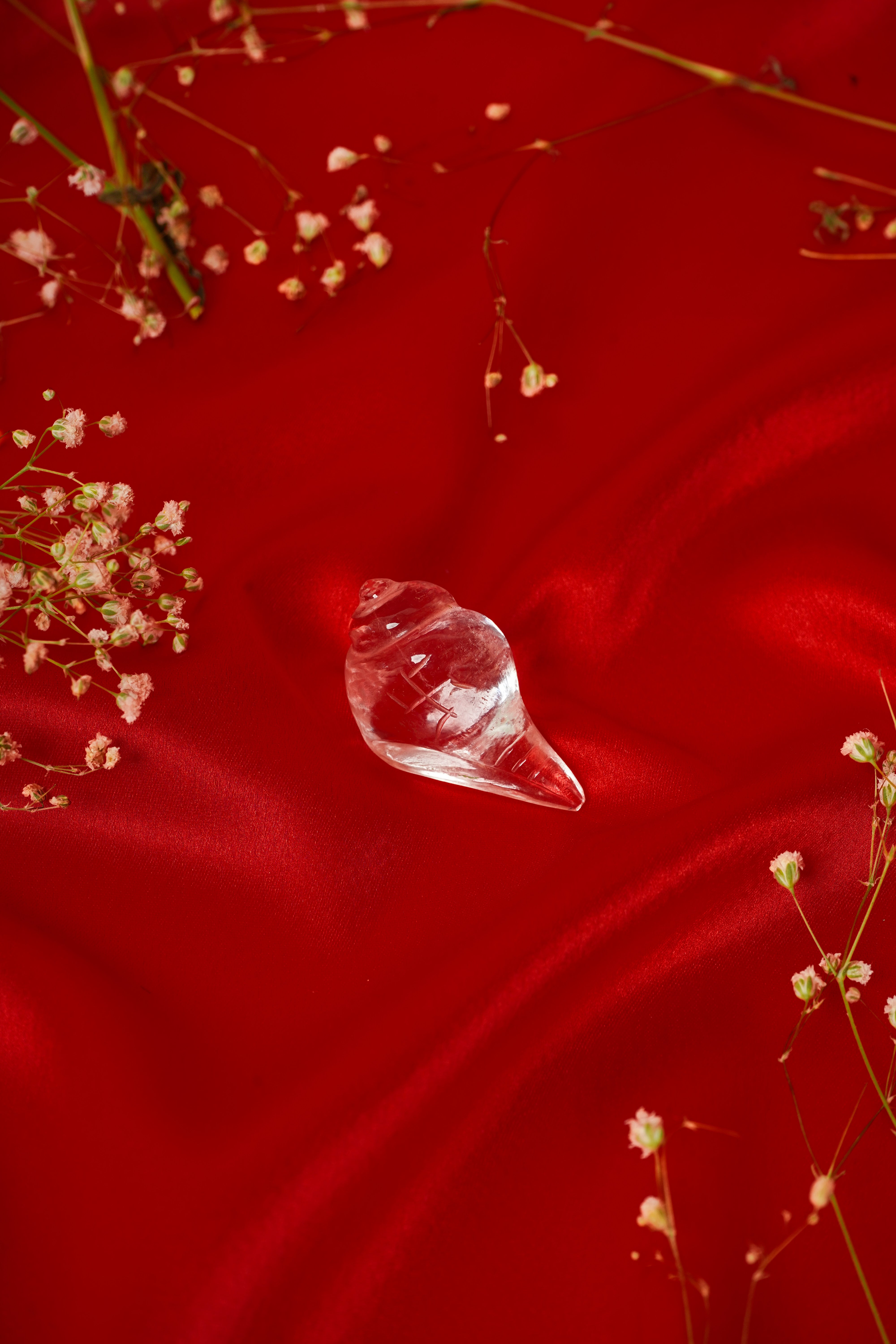 Natural clear quartz shankh shell with smooth, polished surface, showcasing its translucent, white appearance and intricate natural patterns.