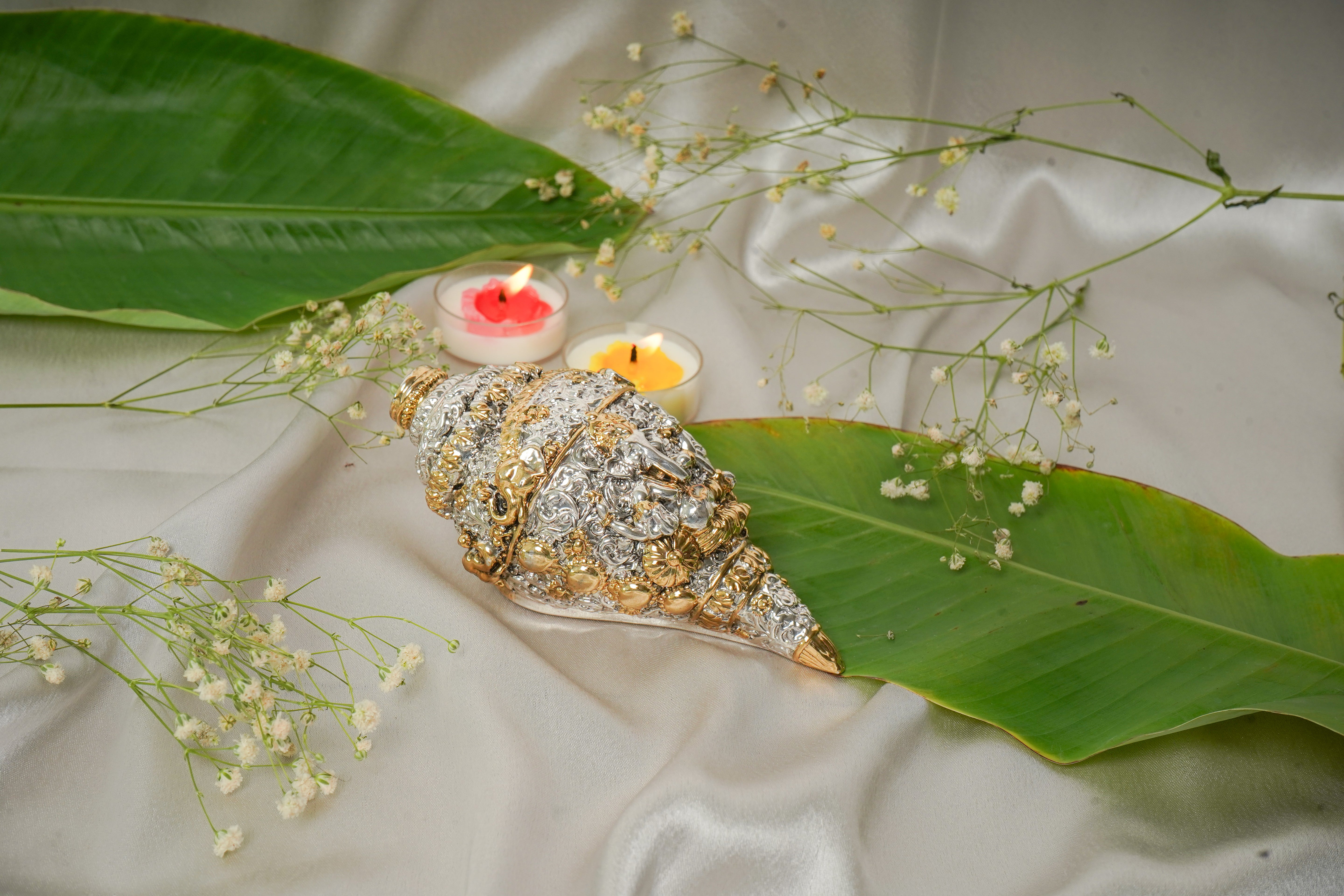 Silver and gold shankh conch shell with intricate detailing, traditional Indian jewelry piece, displayed against a neutral background.