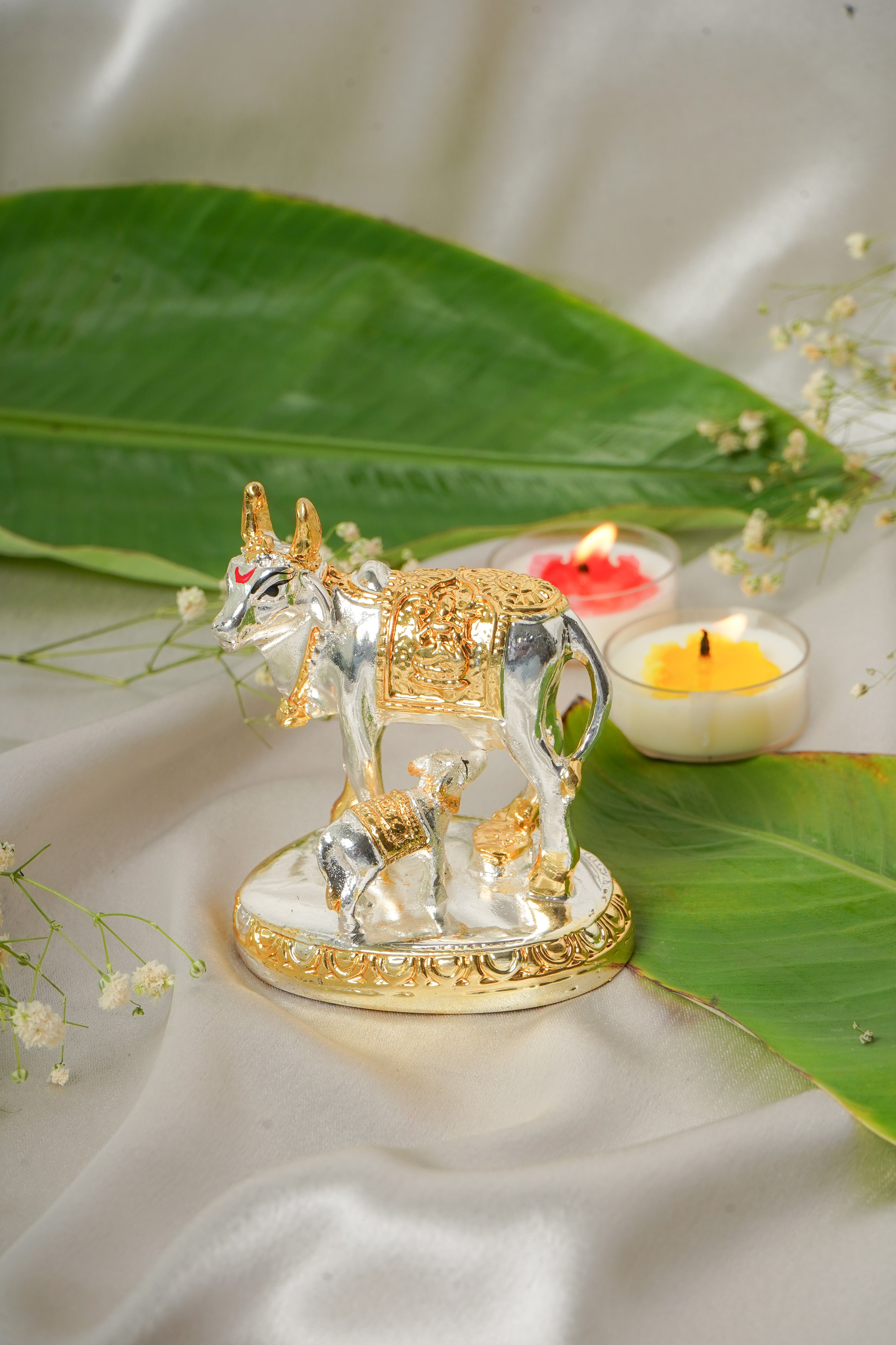 Silver and gold plated cow sculpture with detailed features, showcasing a realistic farm animal design.