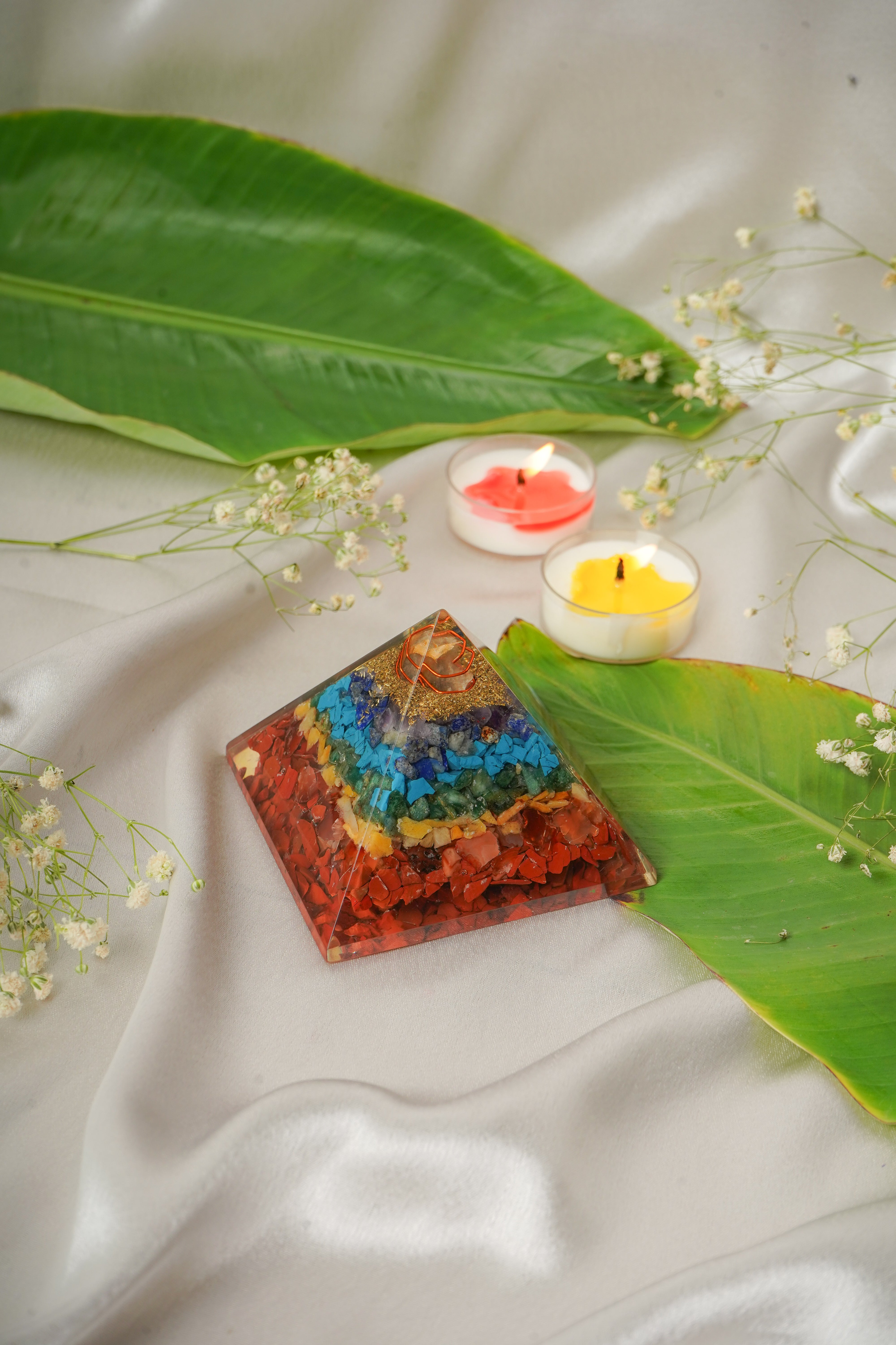 Seven chakra natural stone pyramid, handcrafted crystal sculpture for meditation and energy balancing.