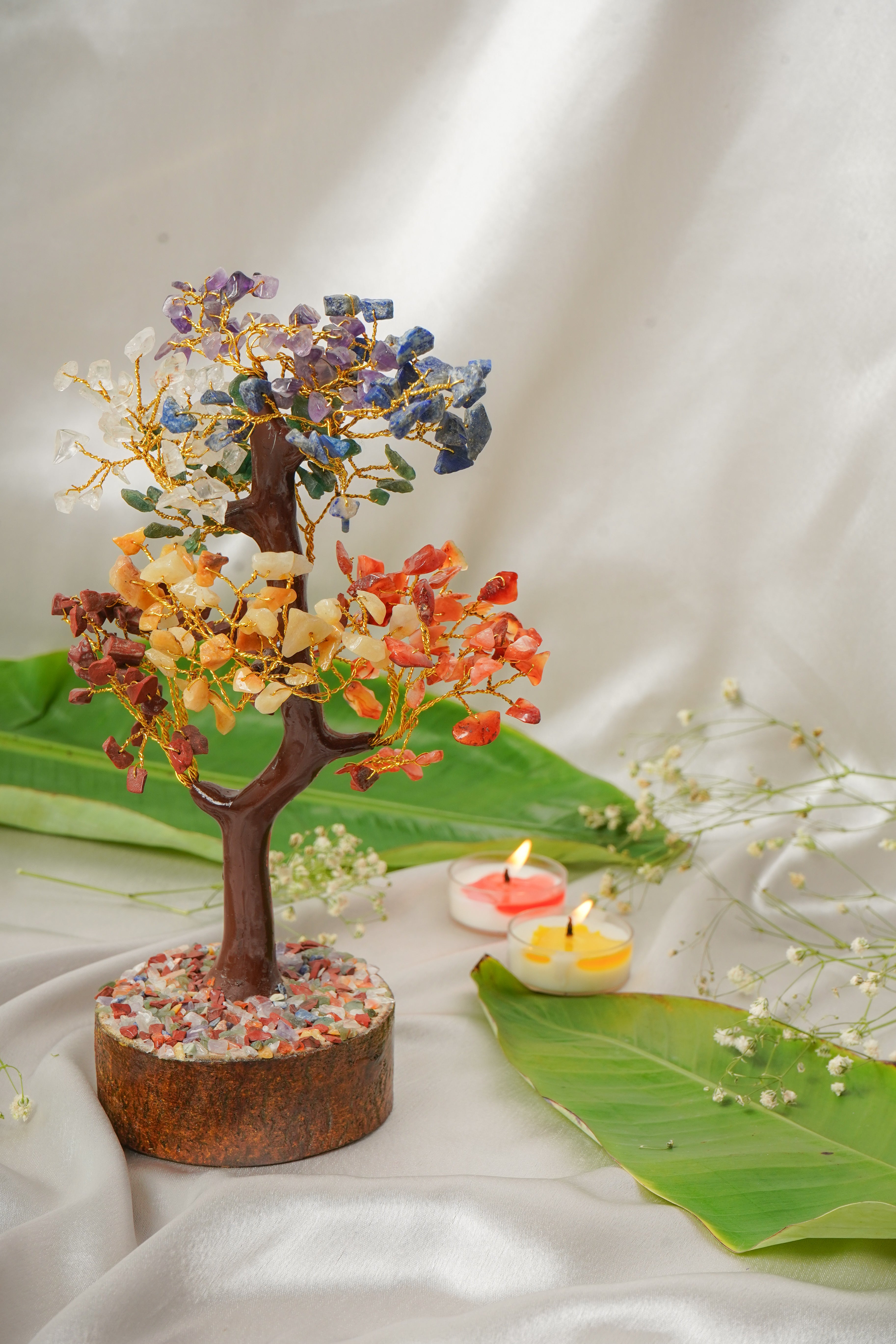 Seven Chakra Natural Stone Tree featuring colorful gemstone leaves and a wooden base, representing spiritual balance and harmony.