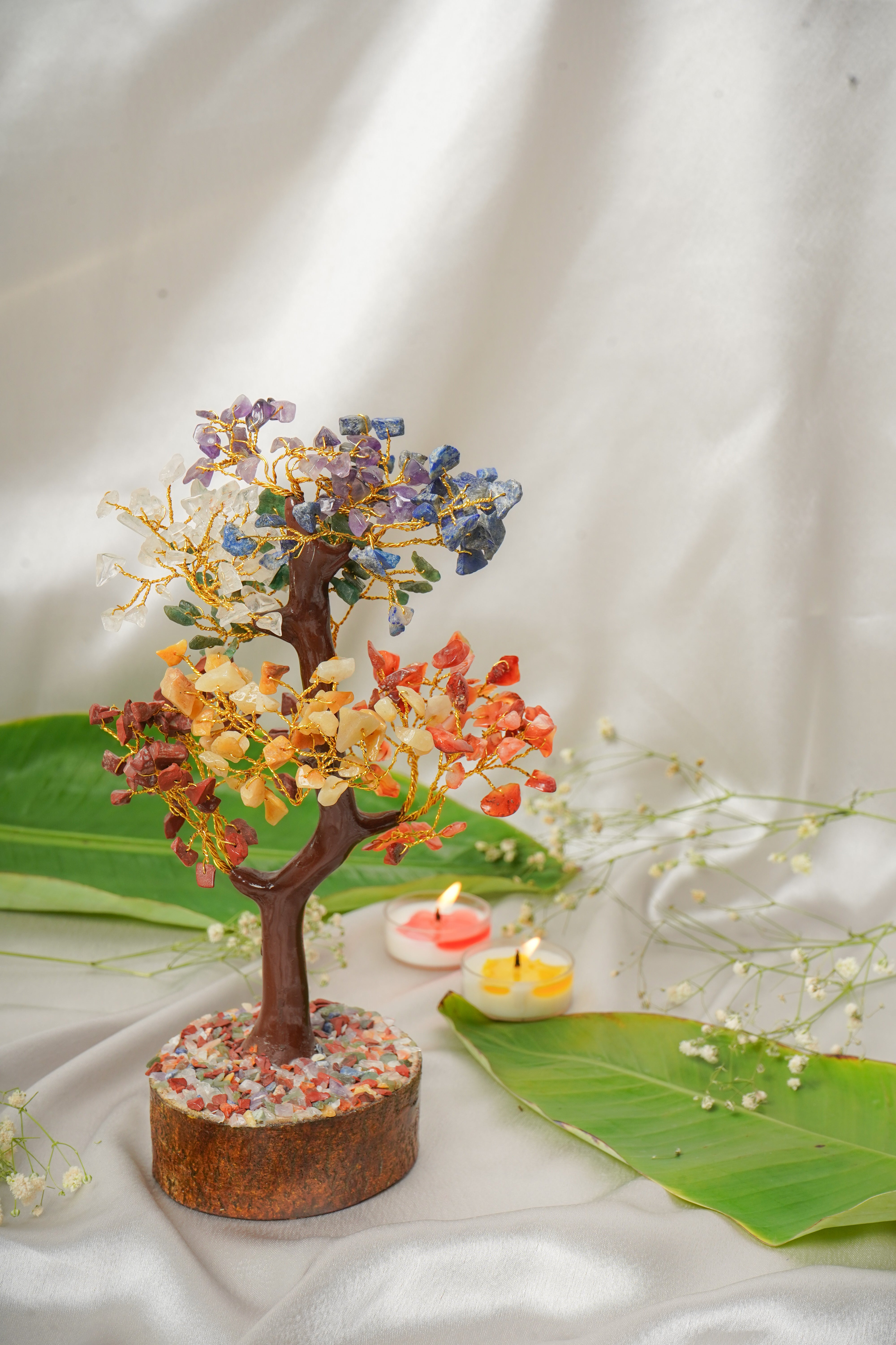 Seven chakra natural stone tree sculpture with colorful stones on a wooden base, representing chakra energies and natural stone craftsmanship.
