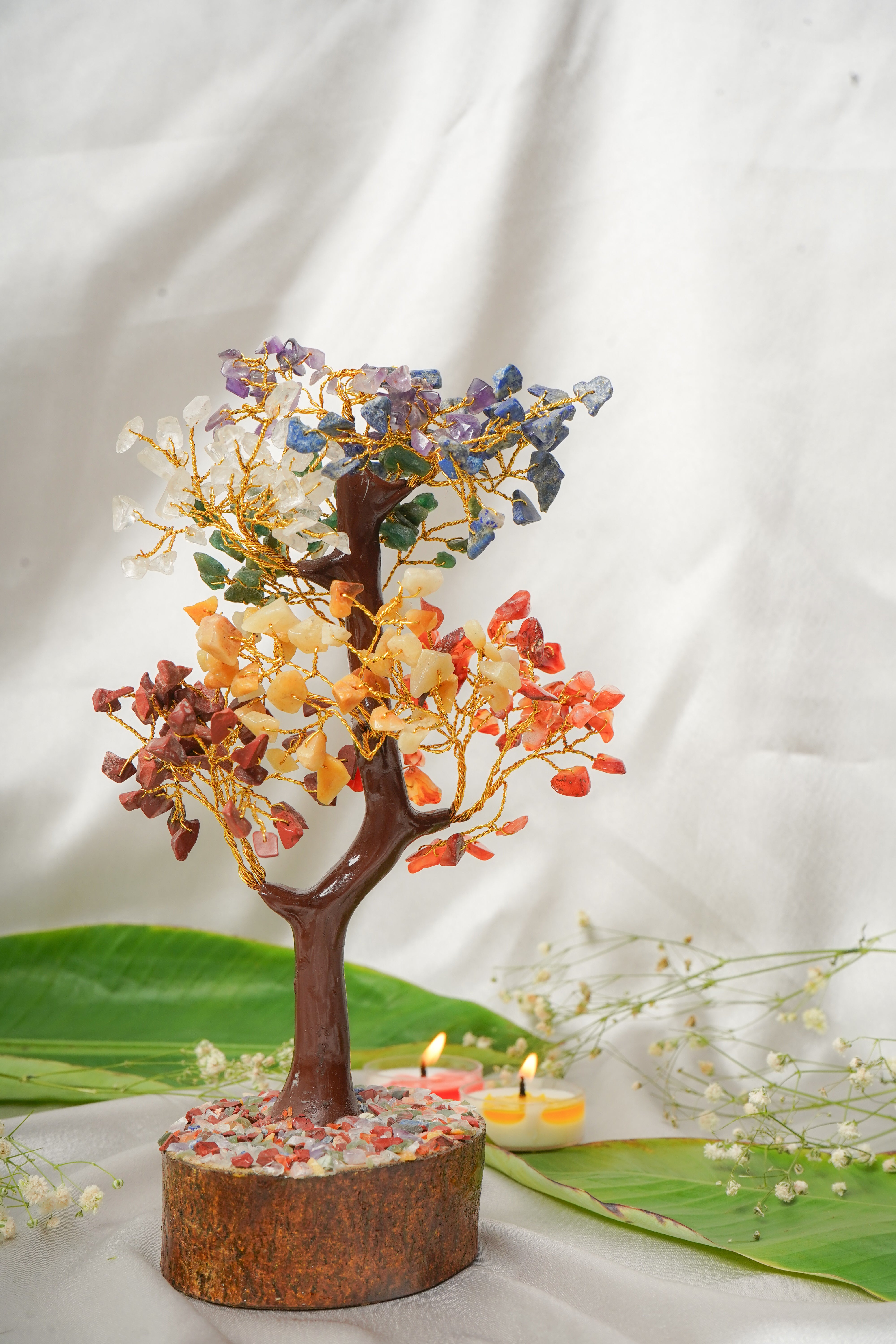 Seven chakra natural stone tree with colorful gemstone leaves and wooden trunk, representing harmony and balance in home decor.