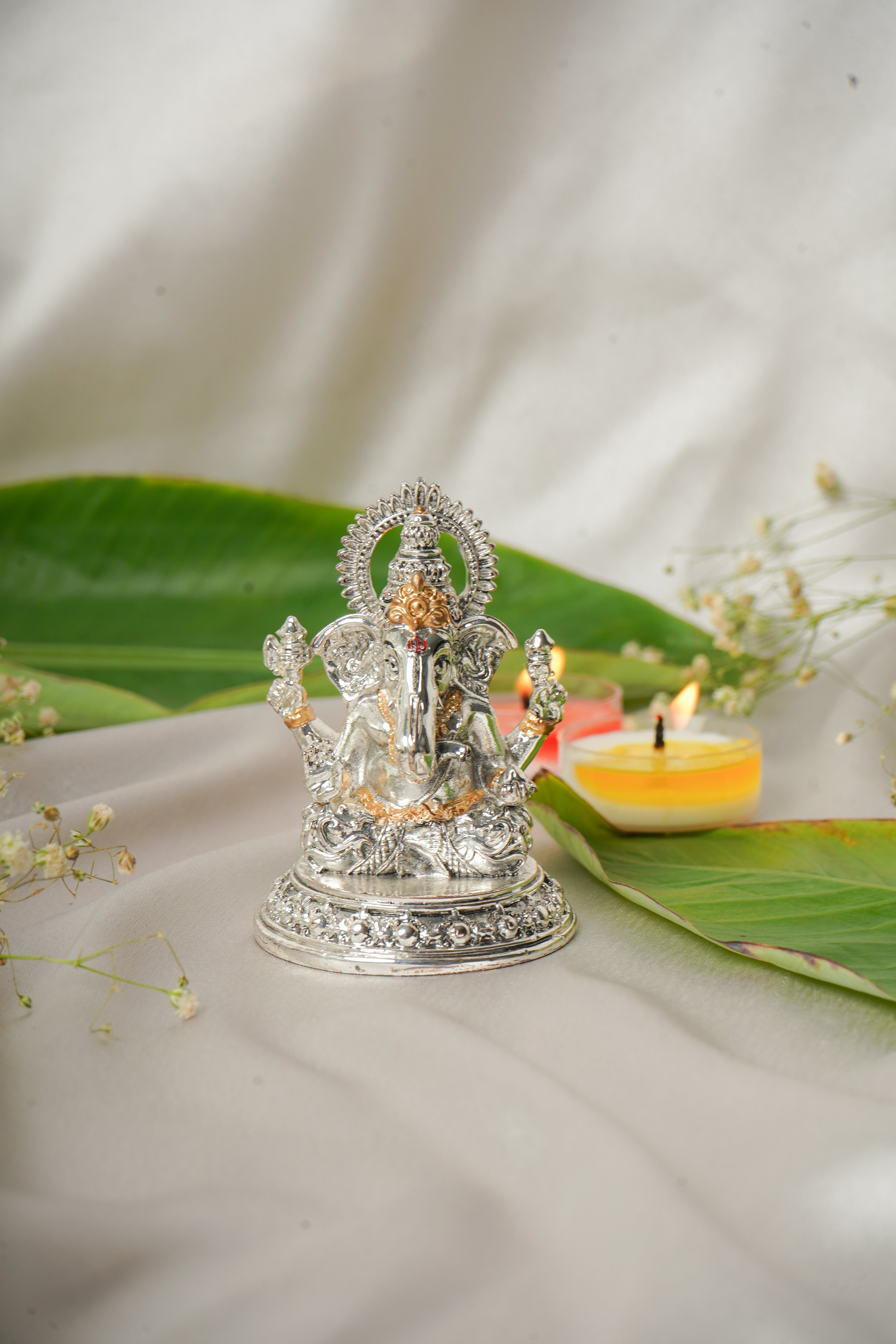 Silver and gold plated Lakshmi and Ganesh Ji figurine, intricately crafted religious deity sculpture for home décor.