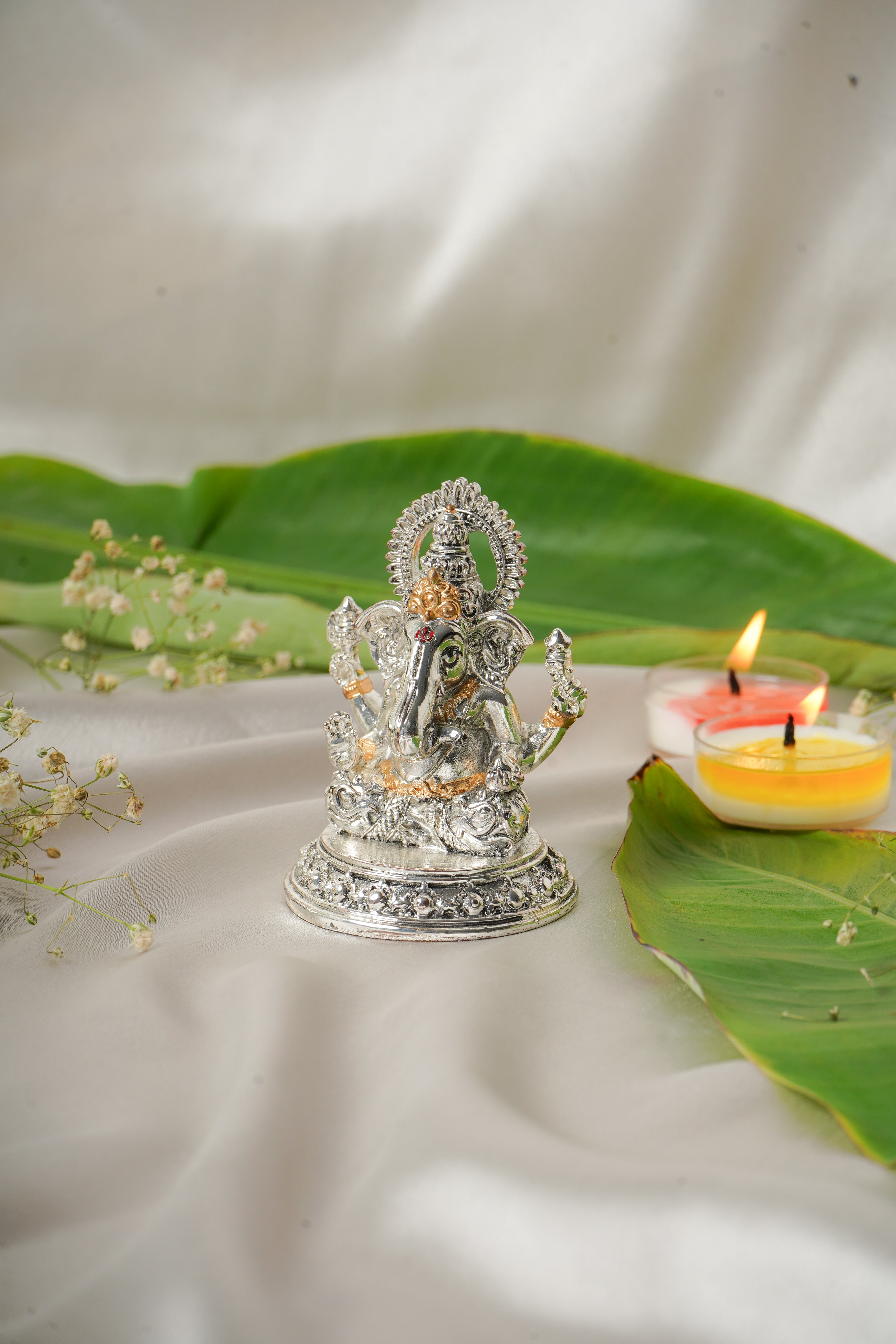 Silver and gold plated Lakshmi and Ganesh Ji idol, intricately crafted religious figurine, showcasing traditional Indian artistry.