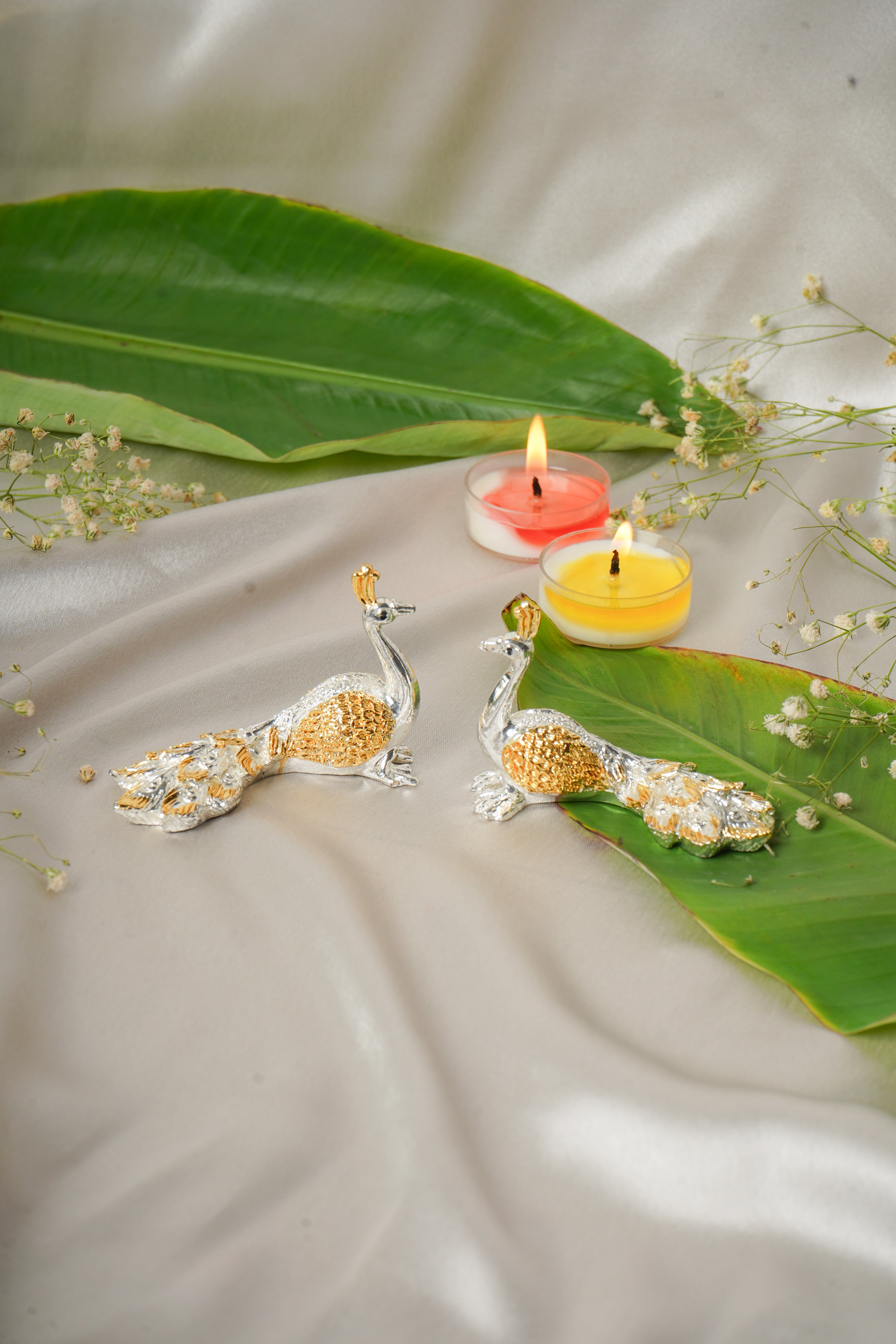 Silver and gold plated peacock-shaped jewelry pair featuring intricate details and vibrant finish, perfect for elegant accessories.
