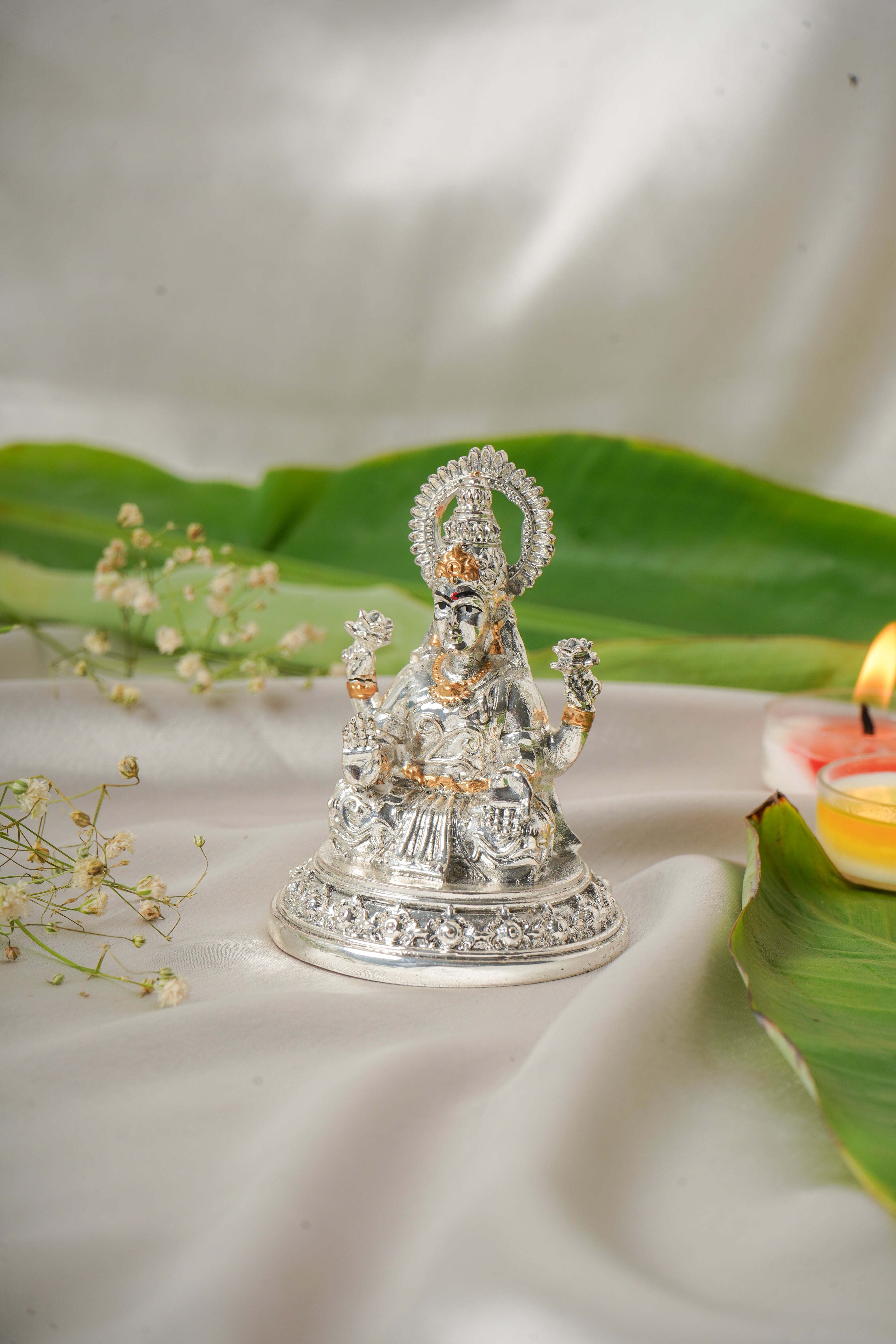 Silver and gold plated Lakshmi and Ganesh ji figurine, intricately crafted Hindu deity statues for home decor.