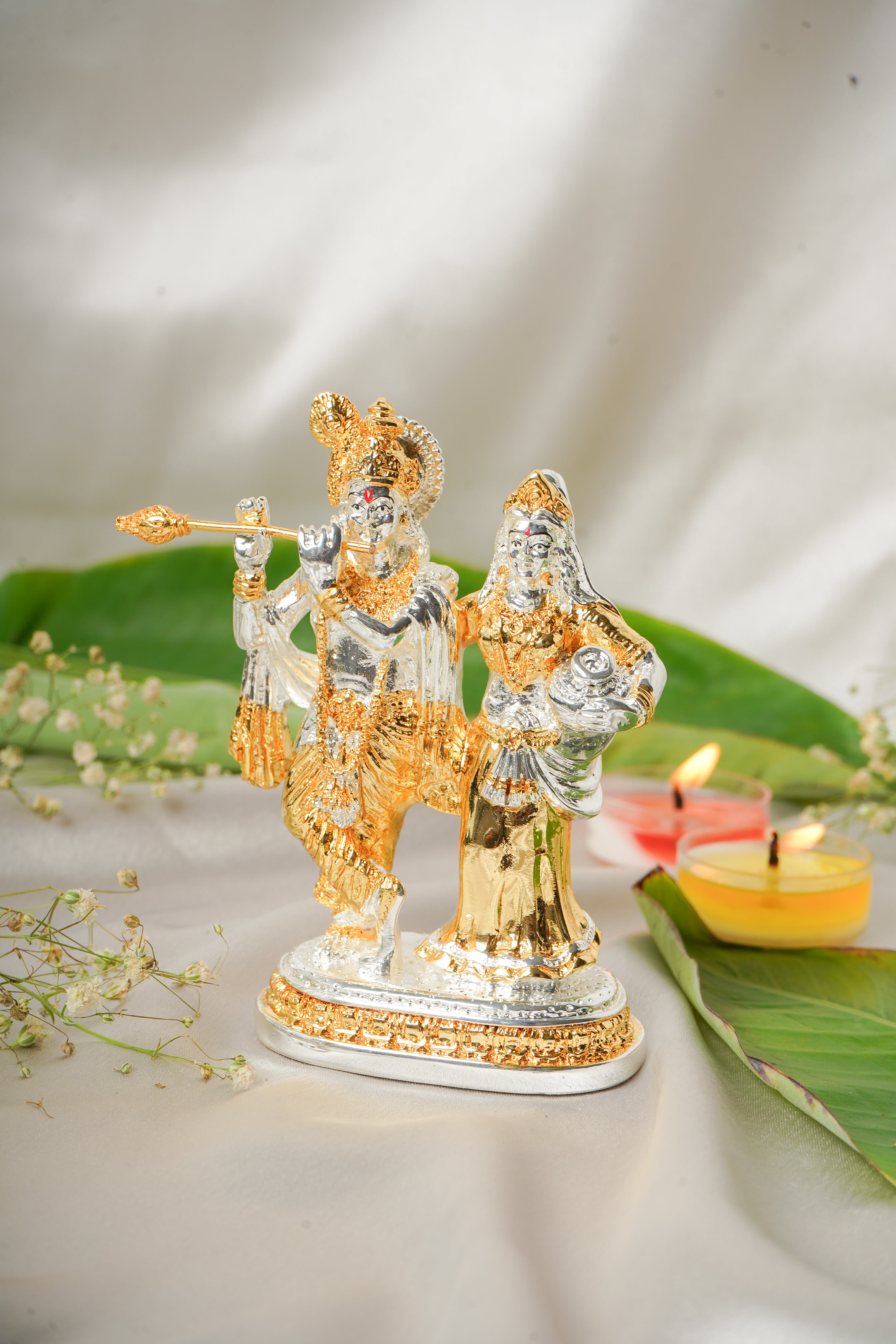 Silver and gold plated Radha Krishna idol with intricate detailing, ideal for spiritual devotion and home decor.