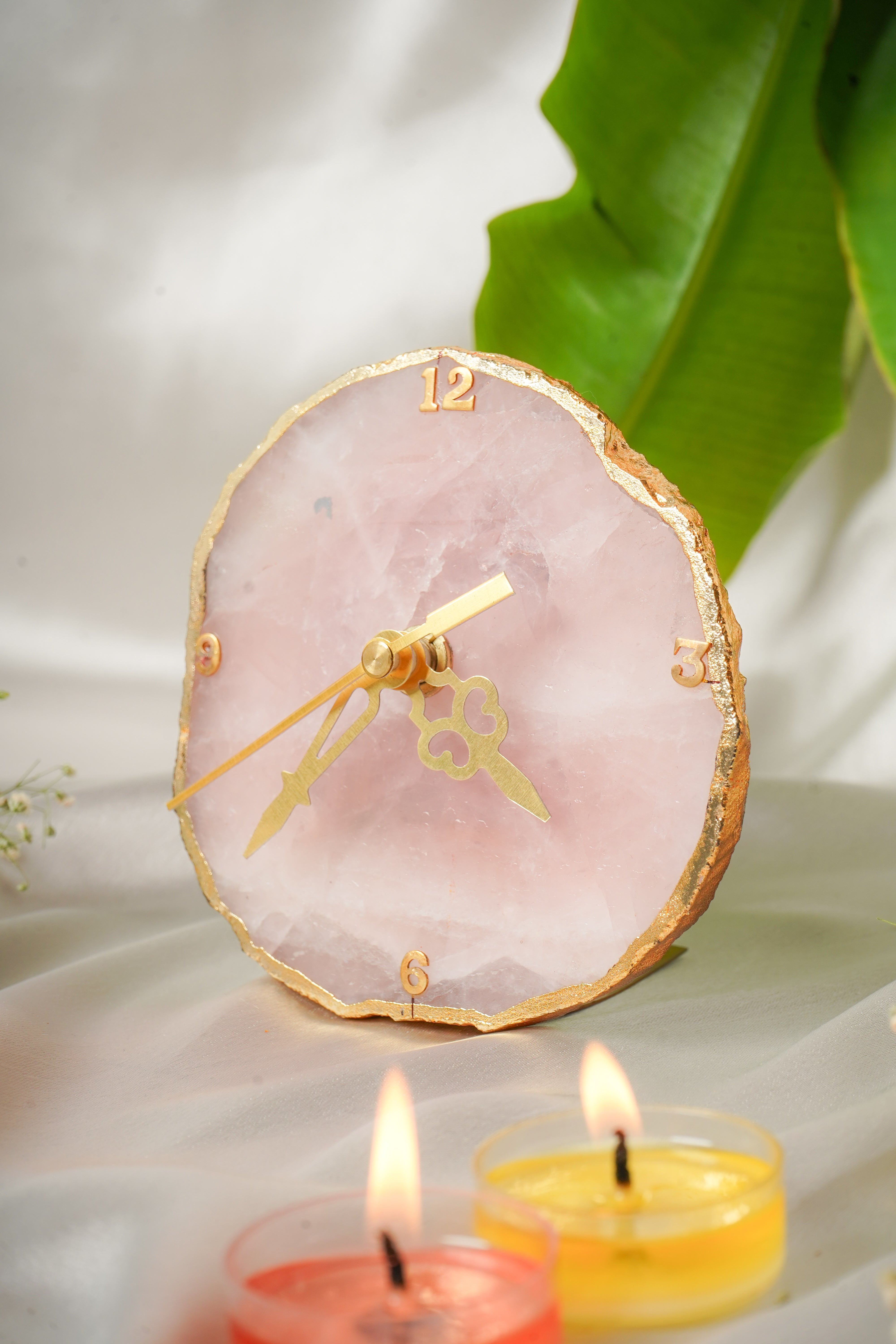 Natural rose quartz table clock with a polished, rectangular shape, featuring subtle pink hues and a smooth surface.
