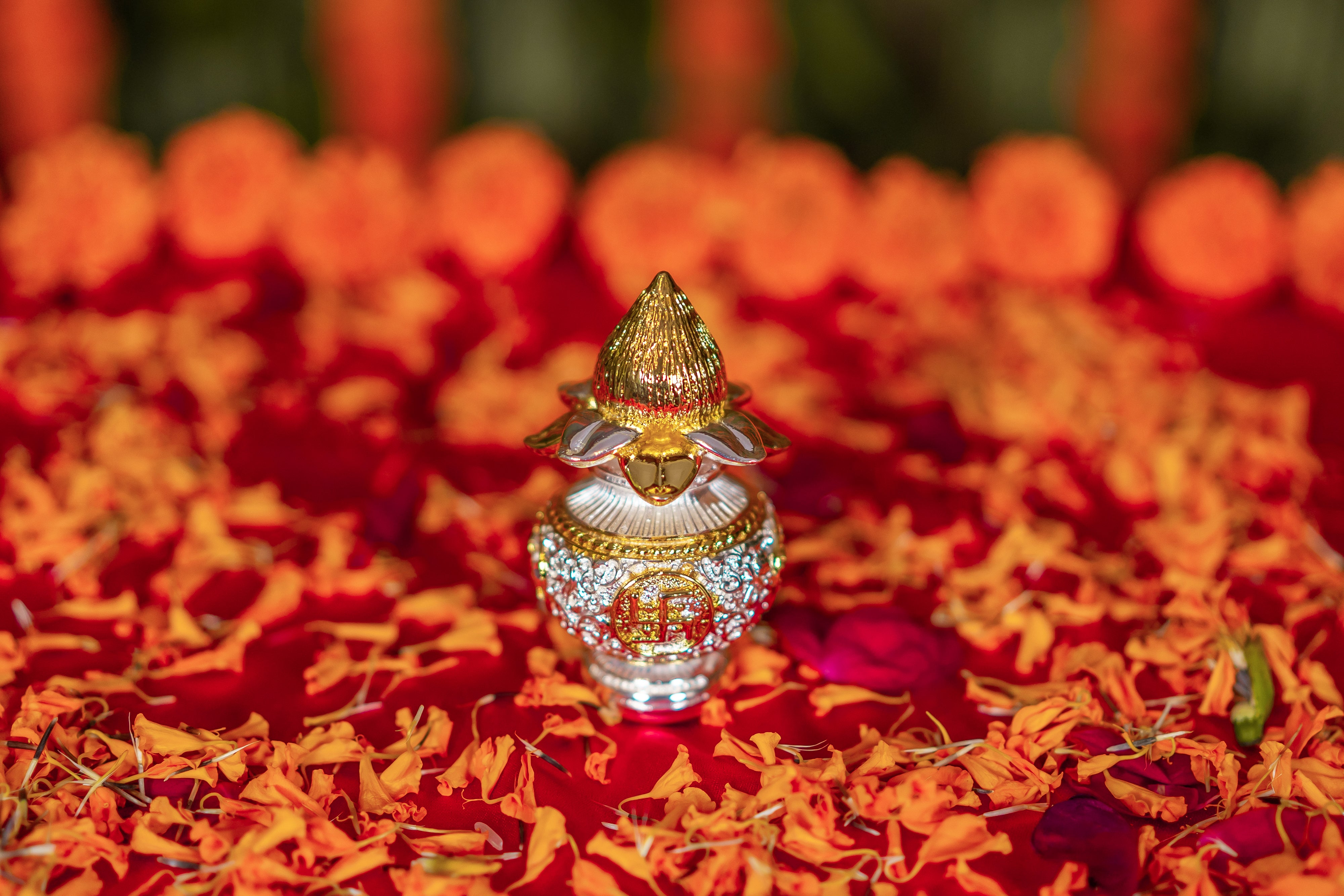 Silver and gold plated Kalash with intricate designs from Rasava Jewels, showcasing traditional Indian metal craftsmanship.