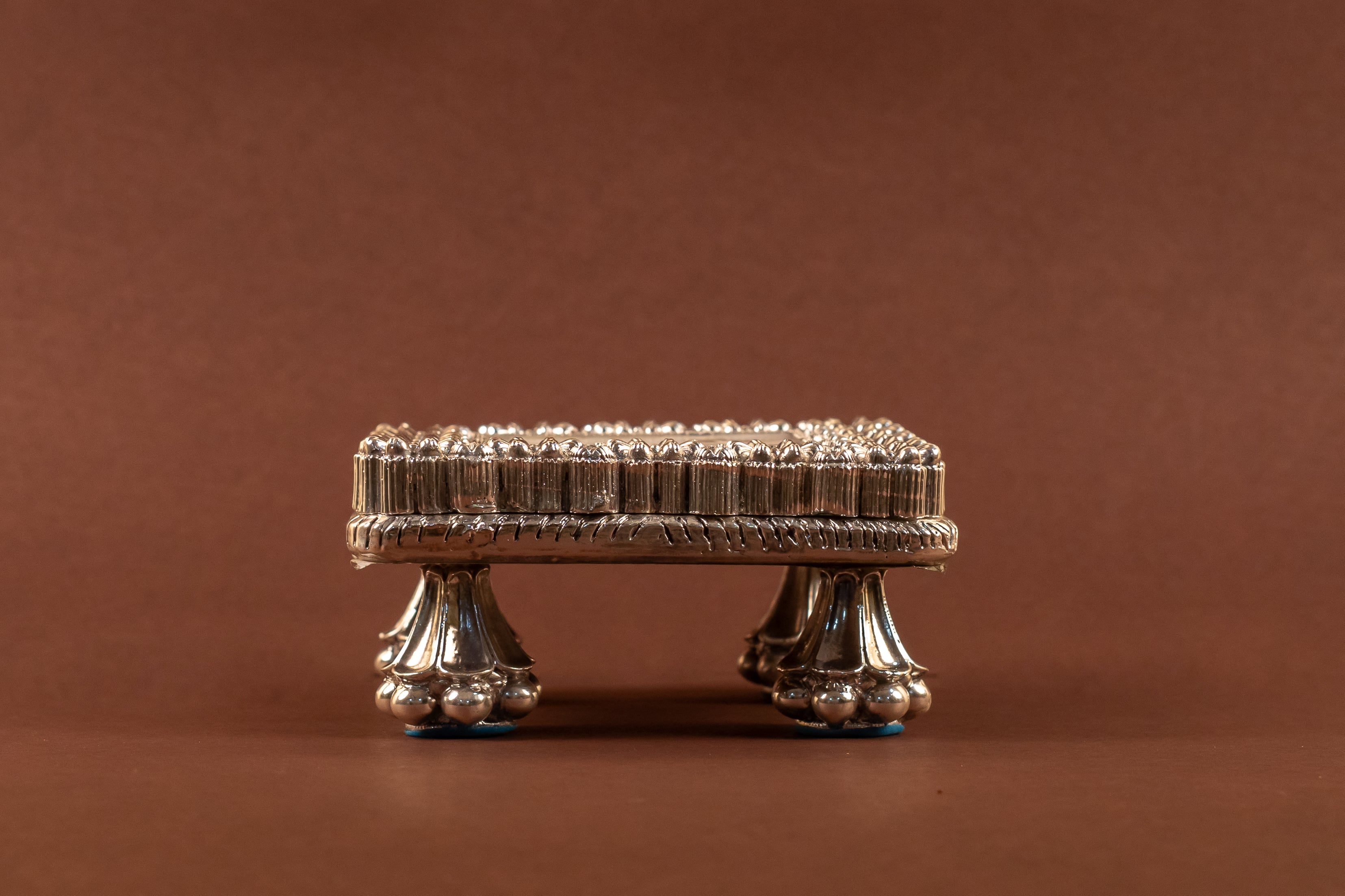 Elegant 999 pure silver MOP chowki from Rasava Jewels featuring intricate craftsmanship and a polished finish.