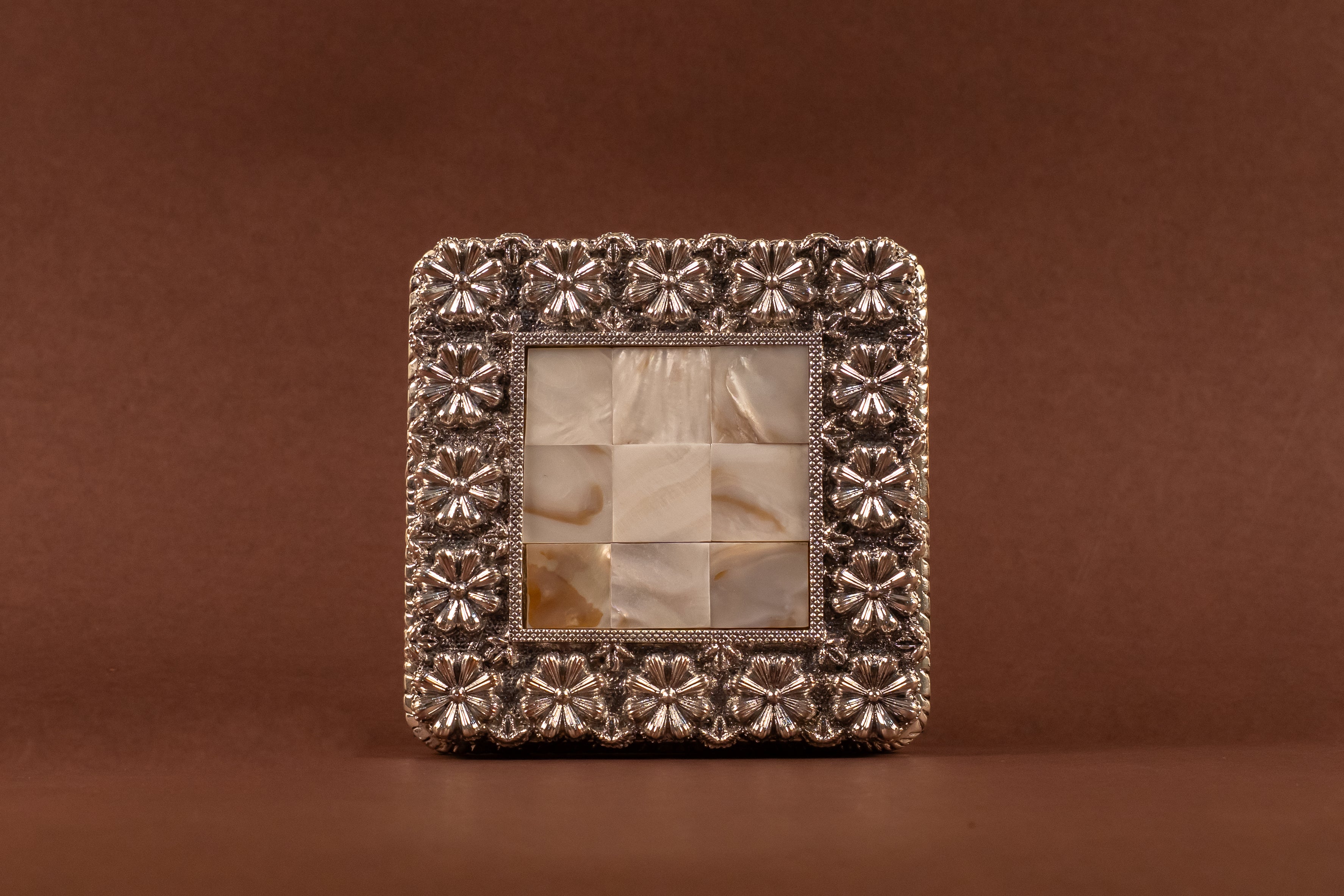 Pure silver MOP chowki by Rasava Jewels featuring intricate craftsmanship and polished silver surface.