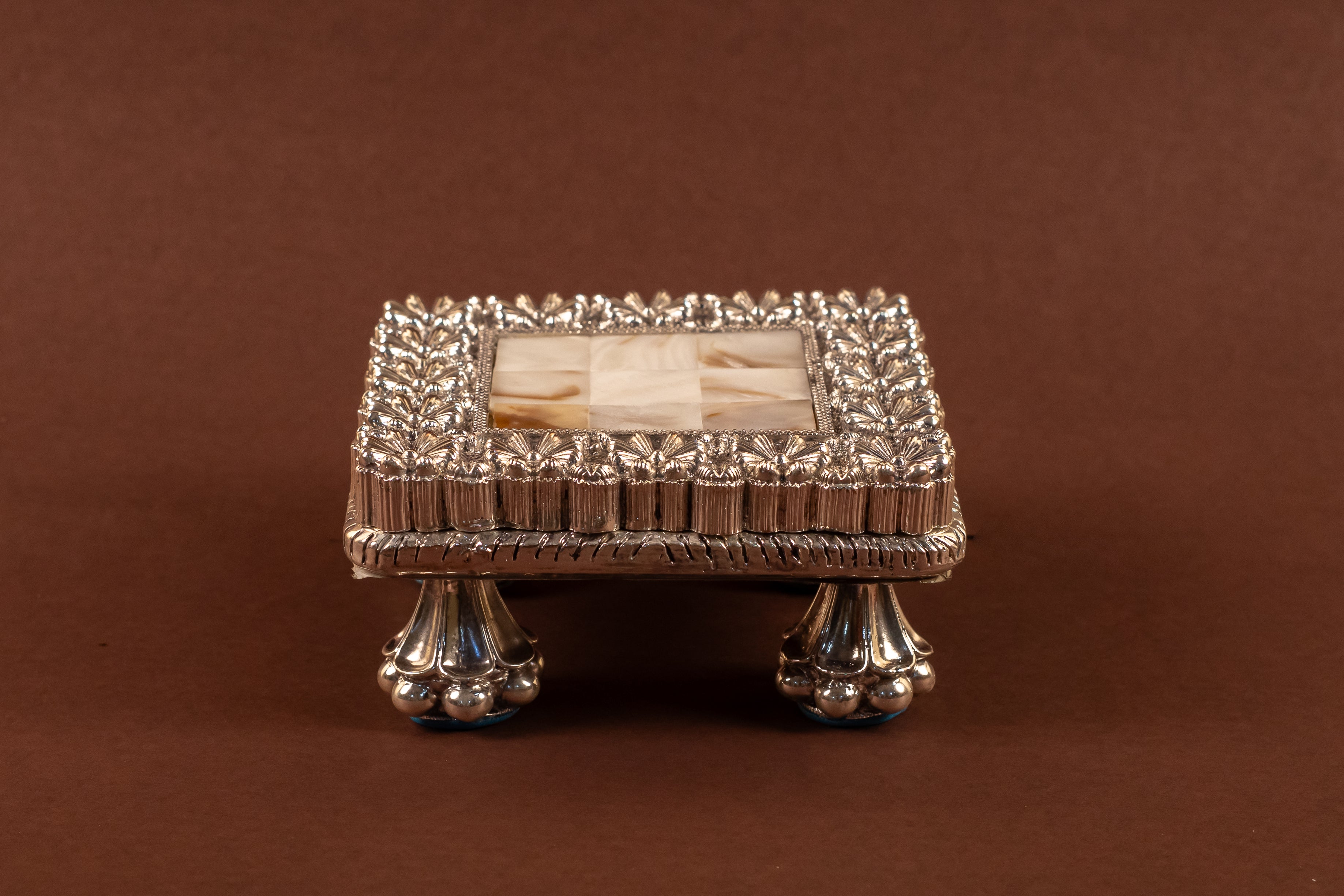 Elegant 999 pure silver MOP Chowki by Rasava Jewels featuring intricate design and polished surface, showcasing traditional craftsmanship.