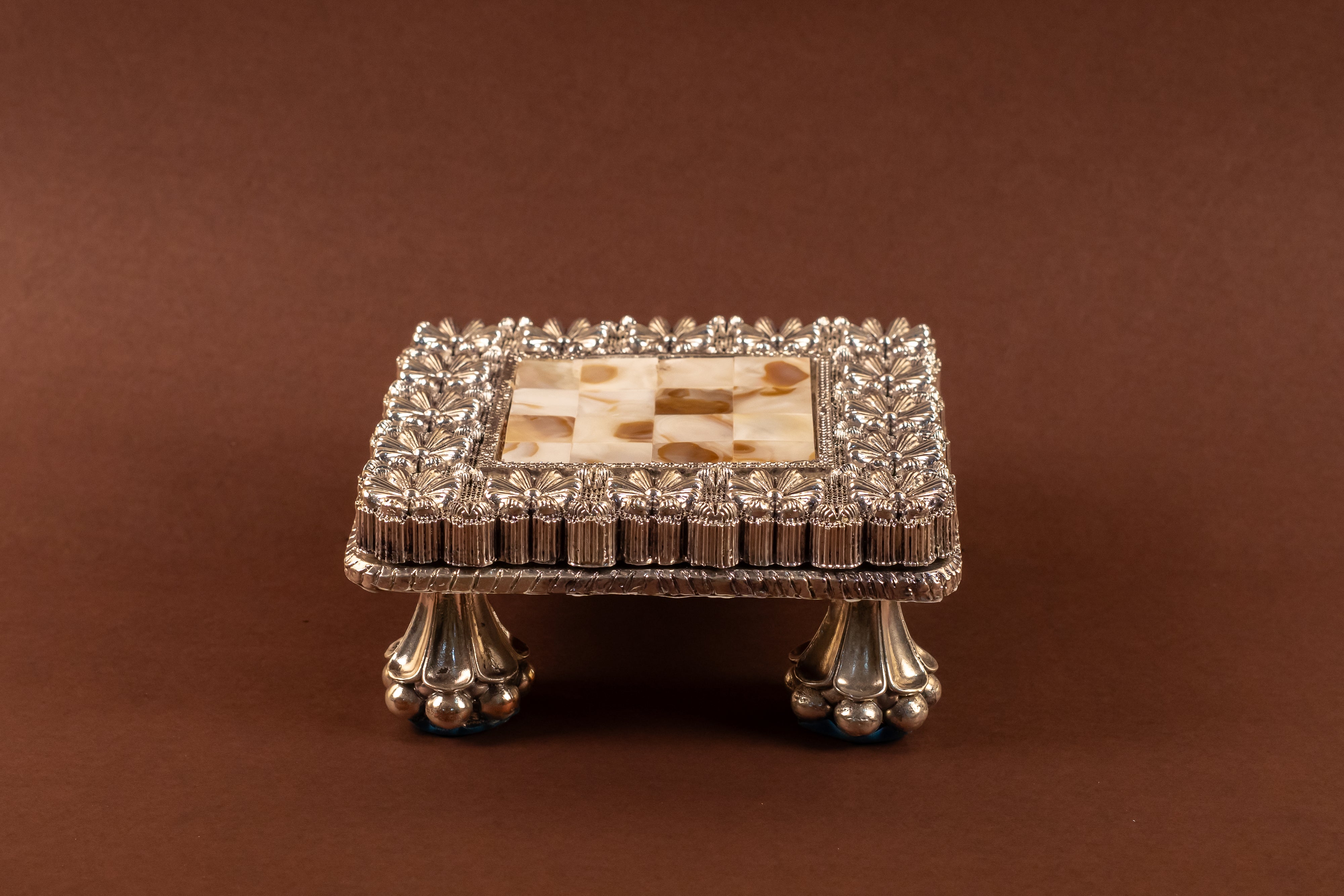 999 pure silver MOP chowki with intricate designs from Rasava Jewels, showcasing traditional craftsmanship and polished finish.