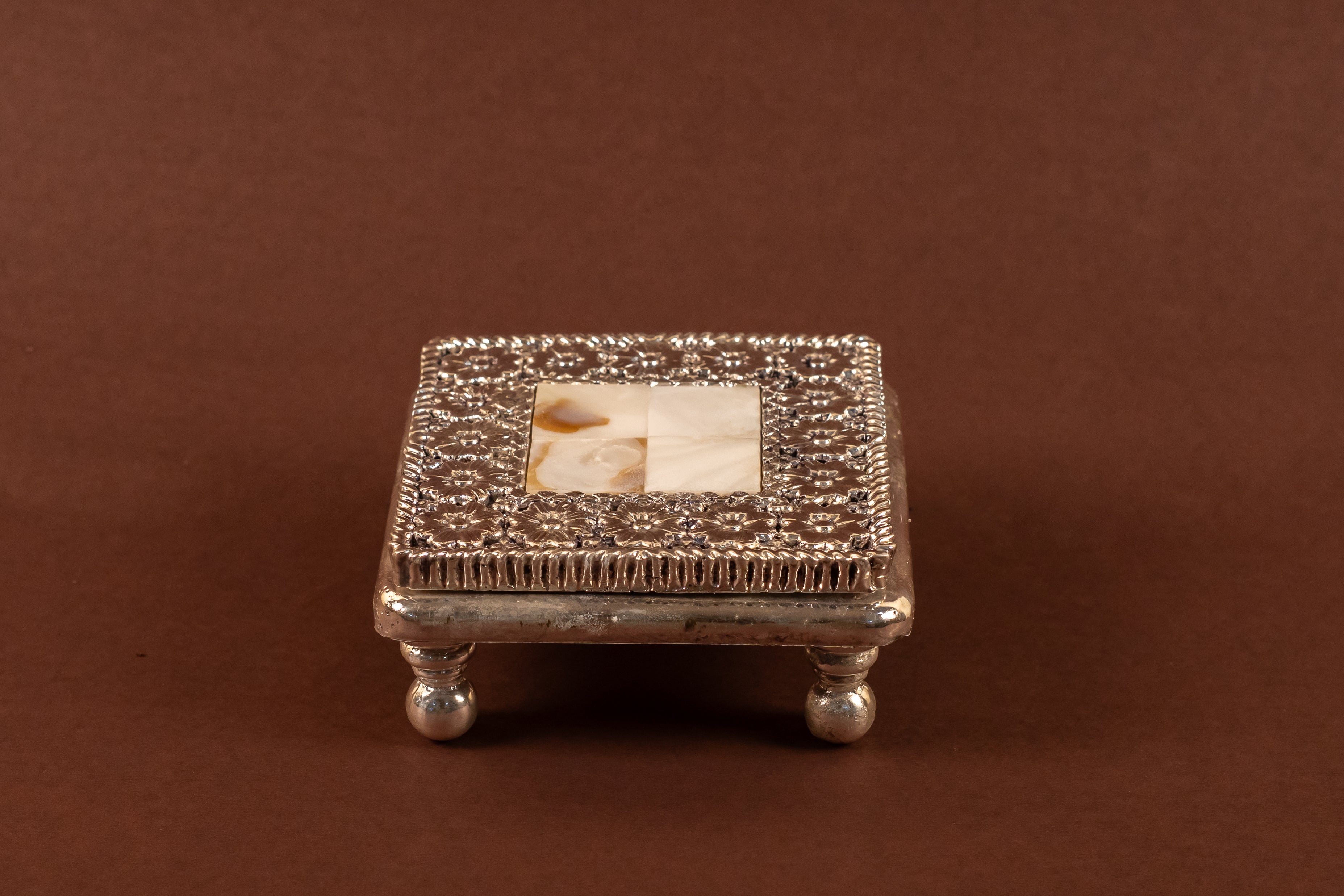 Pure silver MOP chowki with intricate design from Rasava Jewels, showcasing detailed craftsmanship and polished surface.